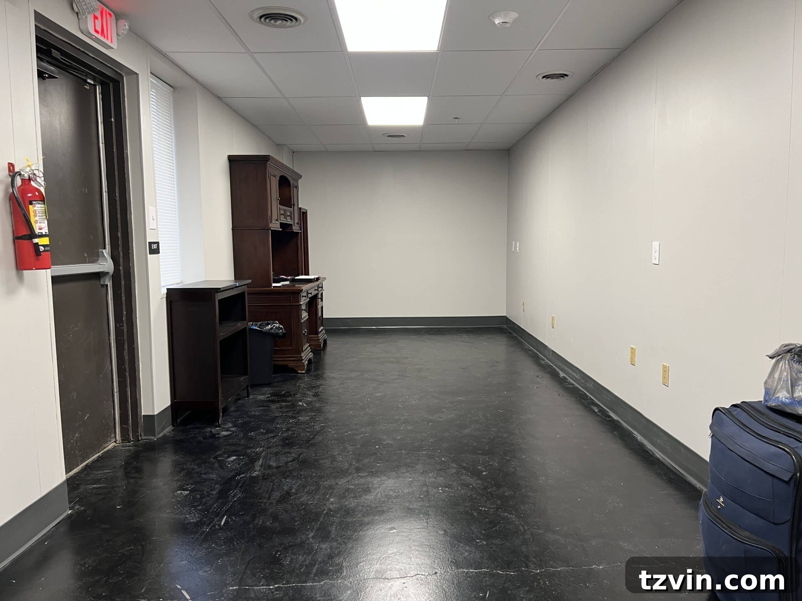 Warm Up Your Workday Cozy Conference Room Ideas for an Office Refresh 3 Before shot of a stark and uninviting conference room, awaiting a transformative makeover.