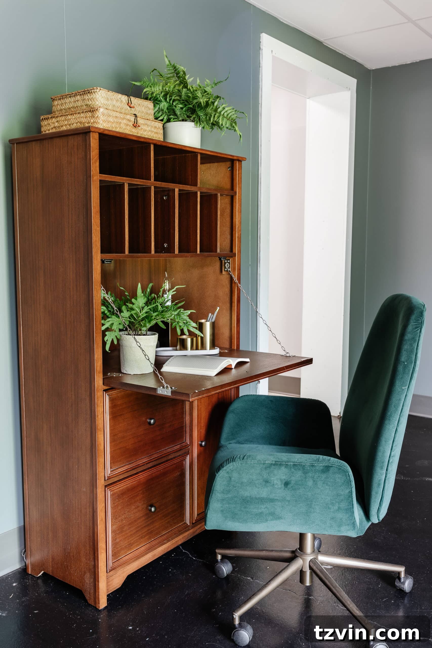 Warm Up Your Workday Cozy Conference Room Ideas for an Office Refresh 24 A functional wooden secretary desk paired with a vibrant green desk chair, showcasing smart storage in an office setting.