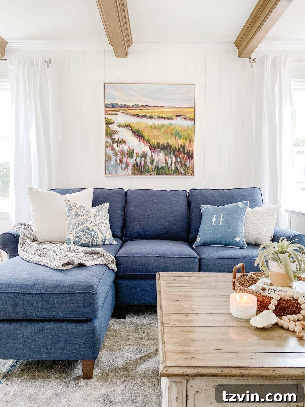 Hang Frames Perfectly Avoid These Common Errors 12 A living room featuring art hung at the ideal height above a sofa, creating a balanced and harmonious space.
