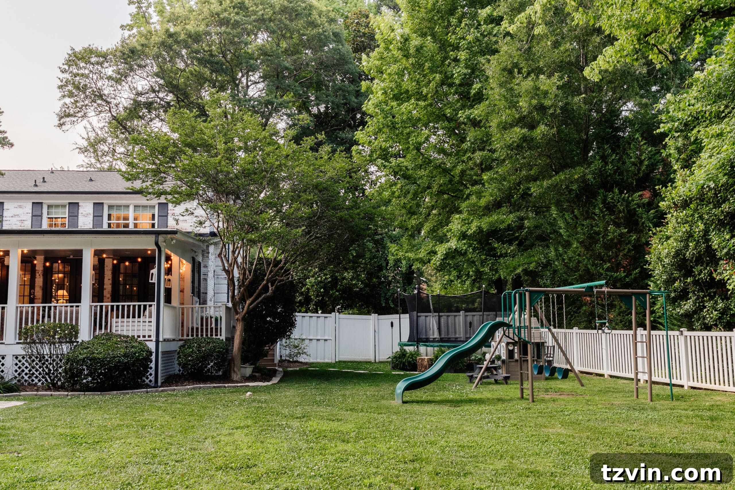 side yard play area with playground and trampoline
