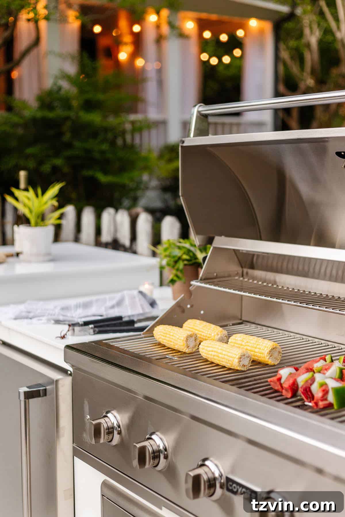 backyard grill with corn on the cob and shish kabobs for a pool party