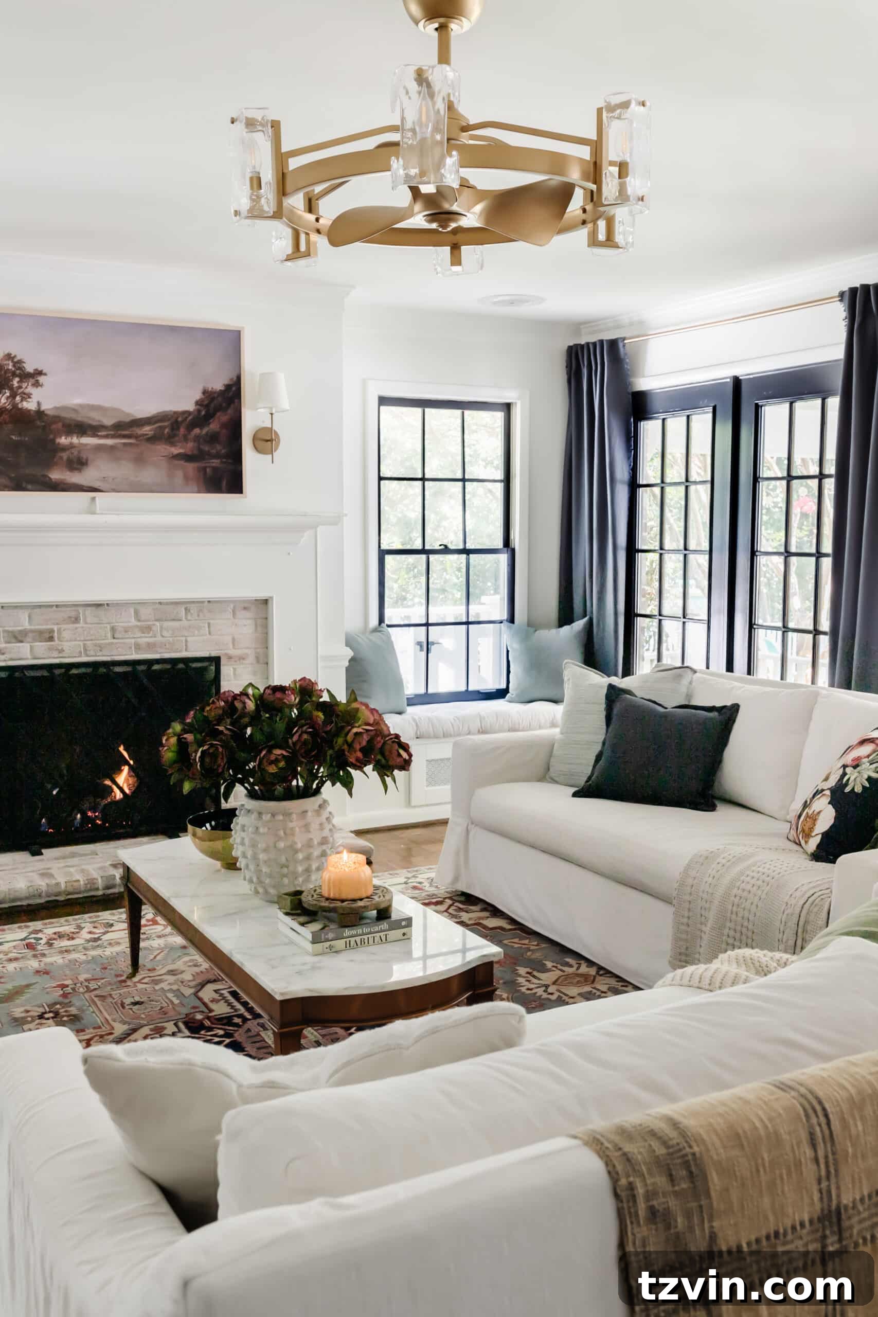 fall living room with blue curtains, vintage rug, and fall art on tv above fireplace