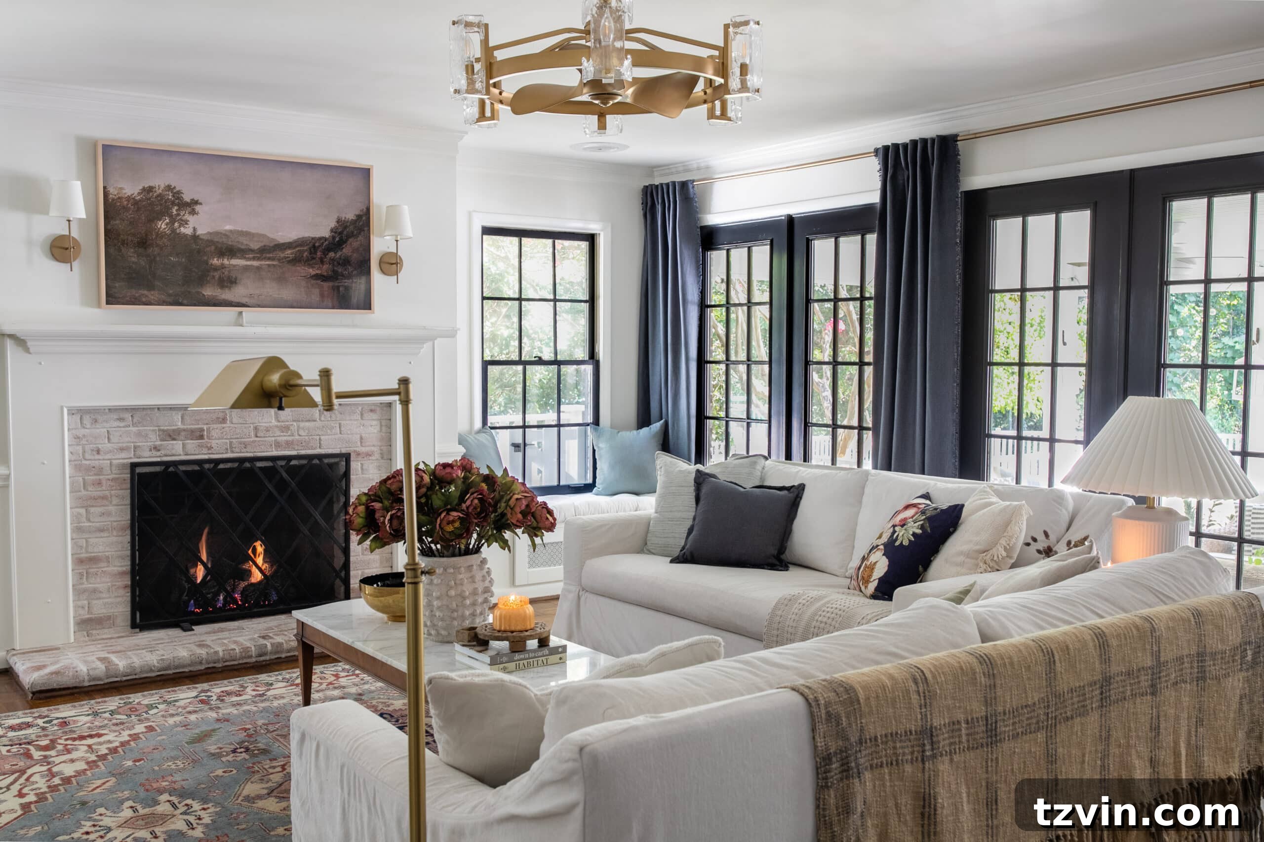 white living room with black windows blue curtains white sofas and fall decor