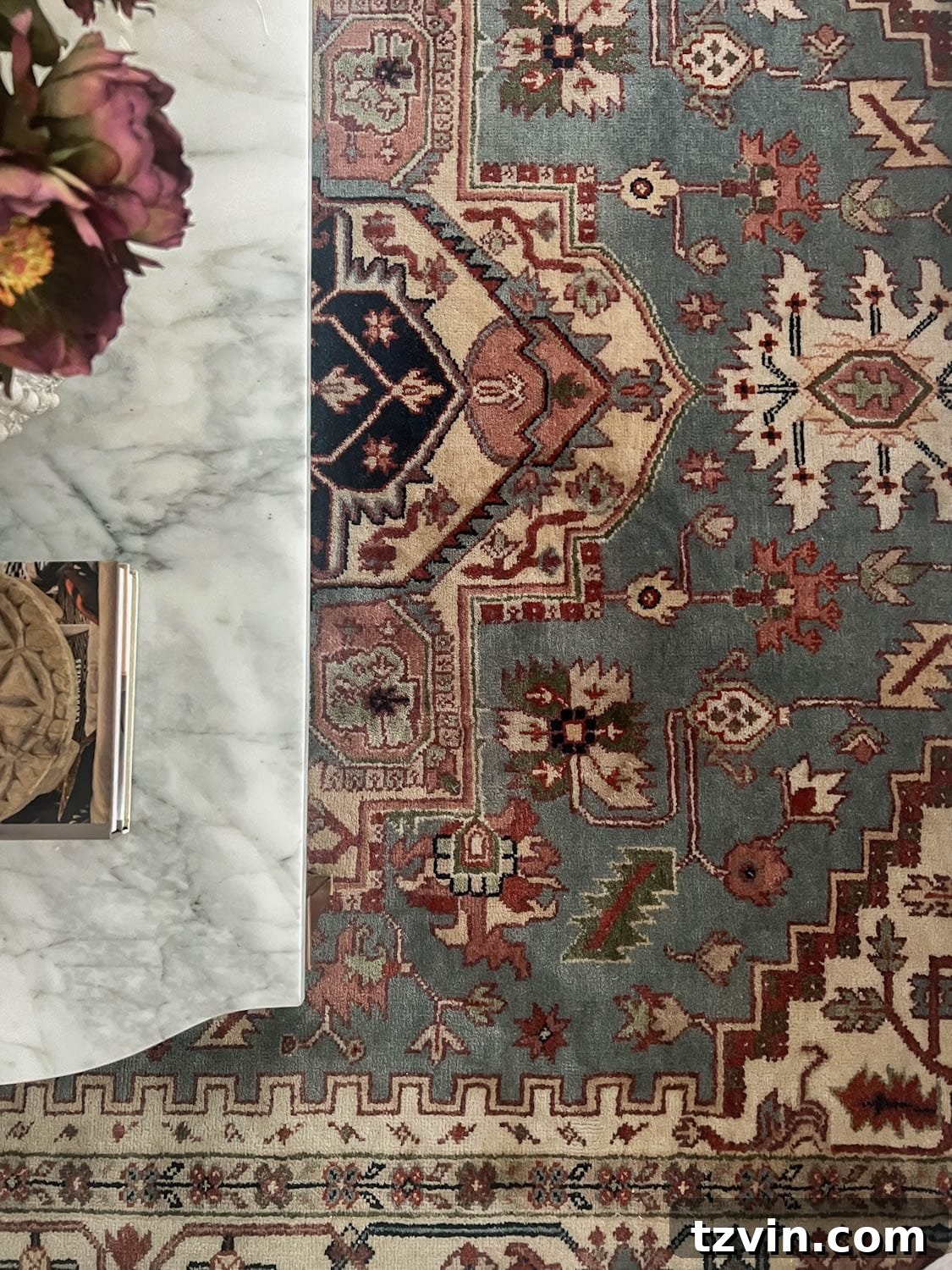 vintage rug with blue, green, burgundy, blush, and cream
