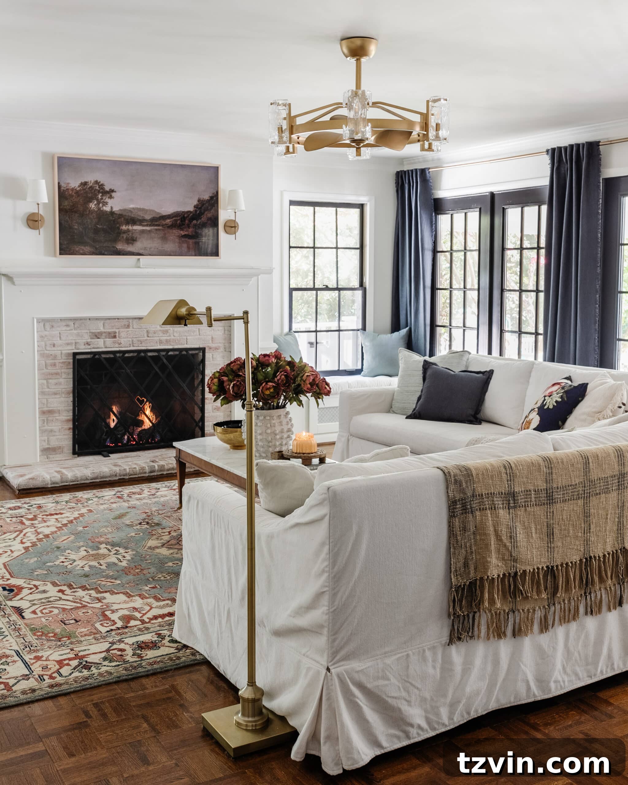 modern traditional living room with brass floor lamp and plaid blanket on back of couch
