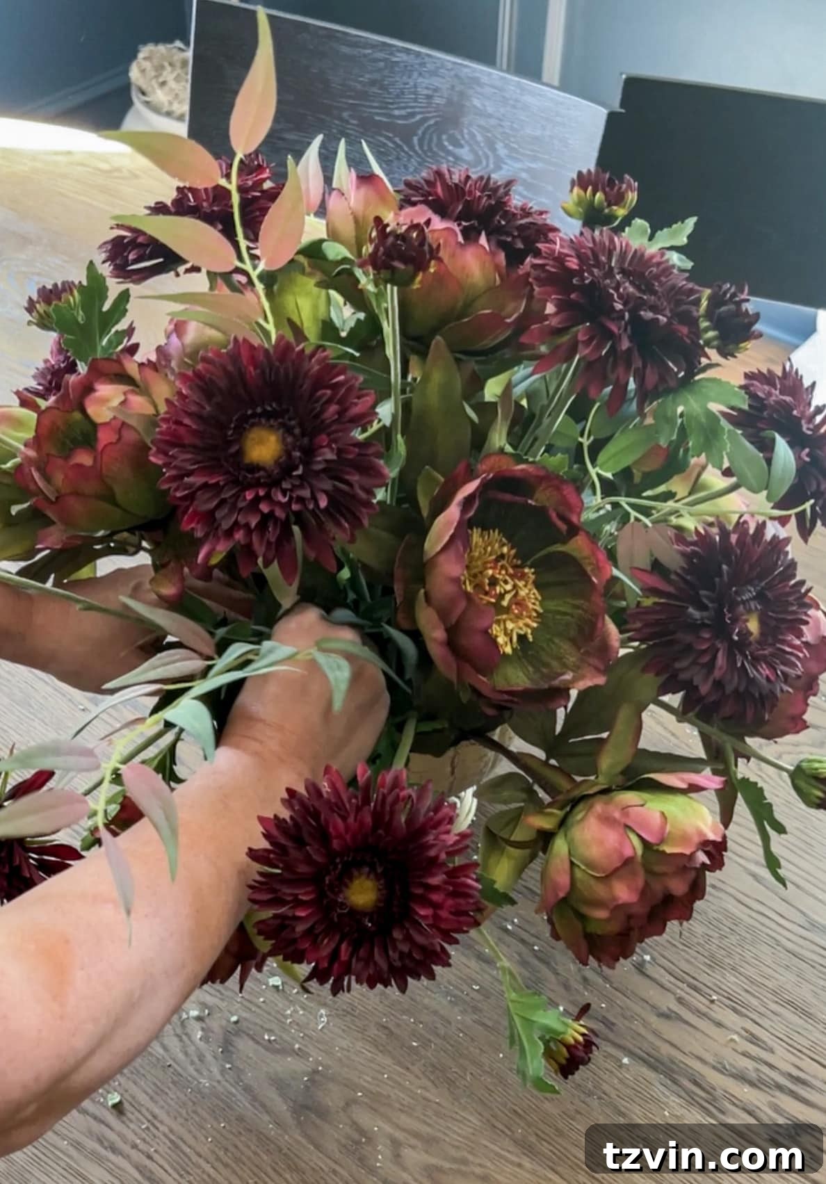 Your Guide to Crafting Beautiful Fall Floral Arrangements 12 Filling leaves into a fall centerpiece to add volume and conceal floral foam