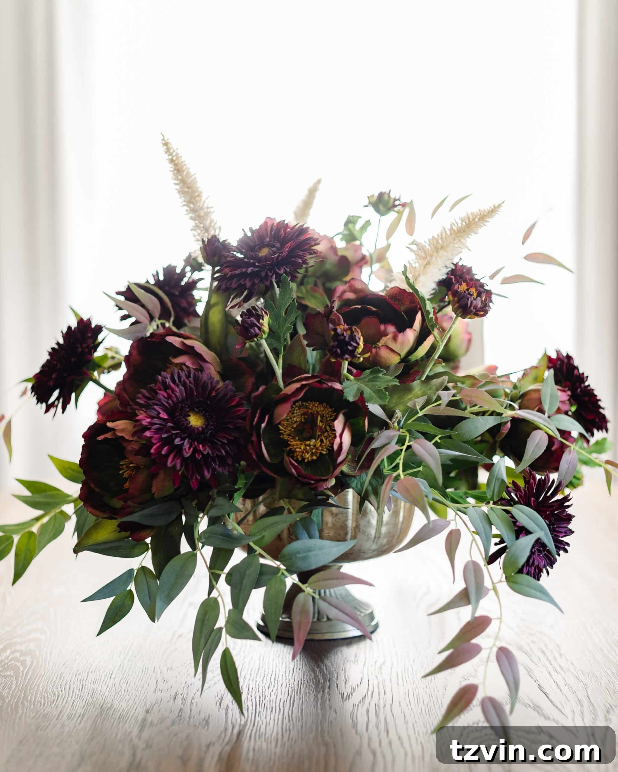 Your Guide to Crafting Beautiful Fall Floral Arrangements 16 Close-up of a fall floral centerpiece showcasing burgundy and purple flowers