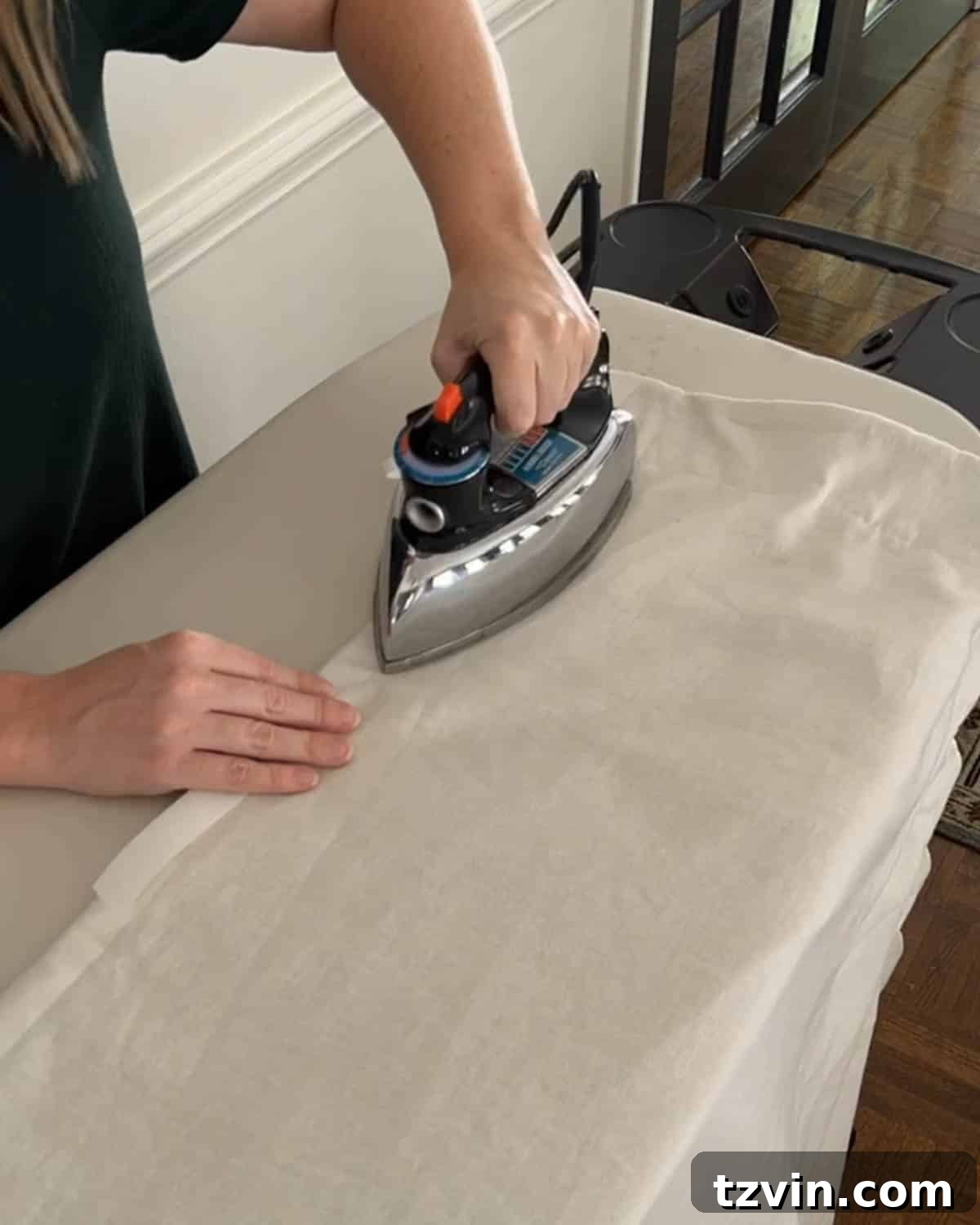 Chic No-Sew Curtains: Easy DIY with Designer Trim 13 Carefully ironing on hemming tape to the edge of a curtain for no-sew trim application