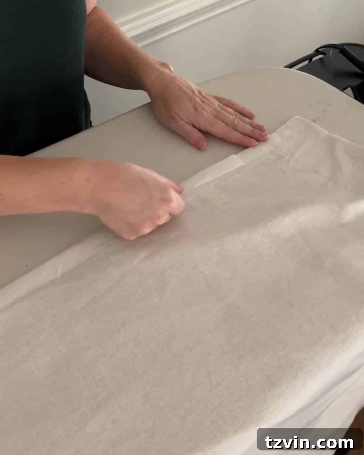Chic No-Sew Curtains: Easy DIY with Designer Trim 14 Applying hemming tape to the side of curtains, preparing for decorative trim
