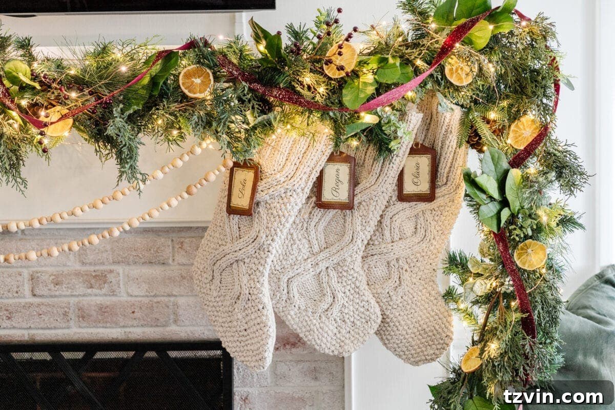 A stunning Colonial Williamsburg-inspired Christmas mantel featuring lush greenery adorned with dried fruits and natural leaves, creating a timeless and elegant holiday display.