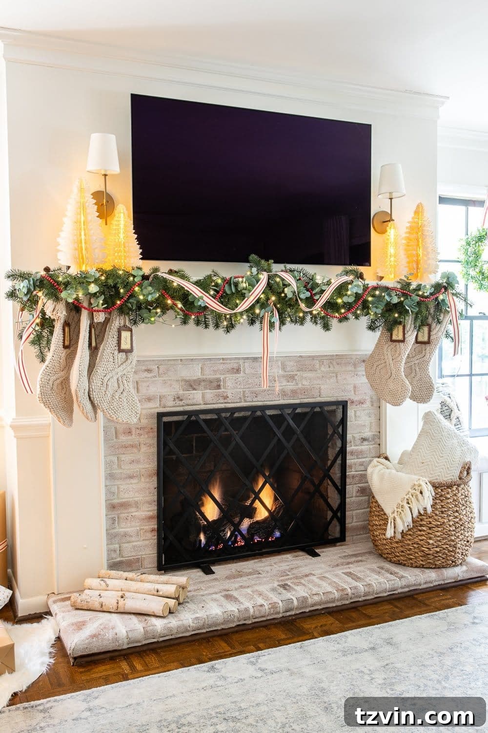 A festive Christmas mantel decorated with a lush eucalyptus pine garland, elegant red unwired ribbon, and a charming cranberry strand, creating a traditional and inviting display.