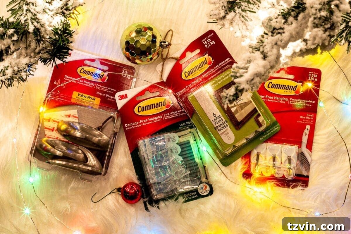 Close-up of Command hooks being used to securely hang Christmas garland on a mantel, illustrating a practical and damage-free decorating solution.