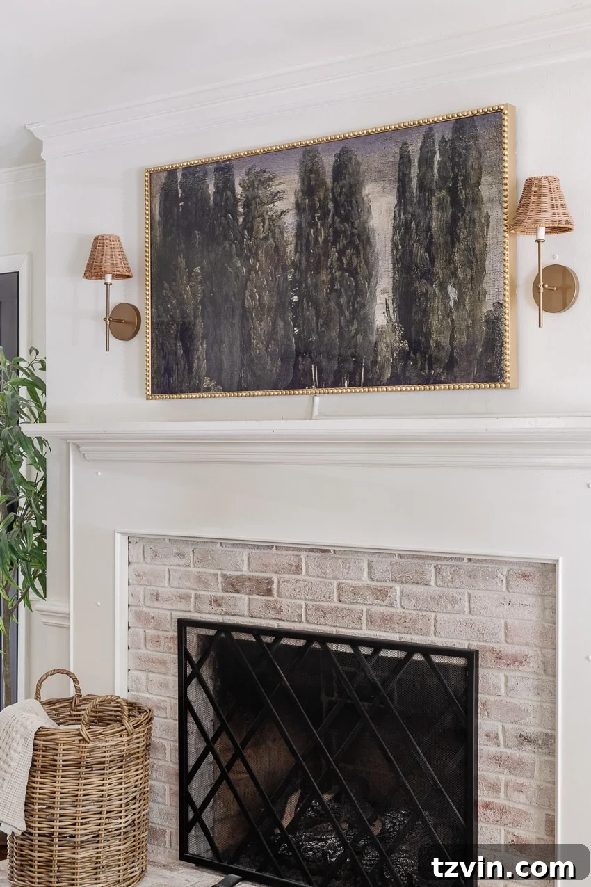DIY Bobbin Bezel for Samsung Frame TV 8 DIY bobbin frame on a Samsung frame TV + rattan sconces above a limewashed brick fireplace