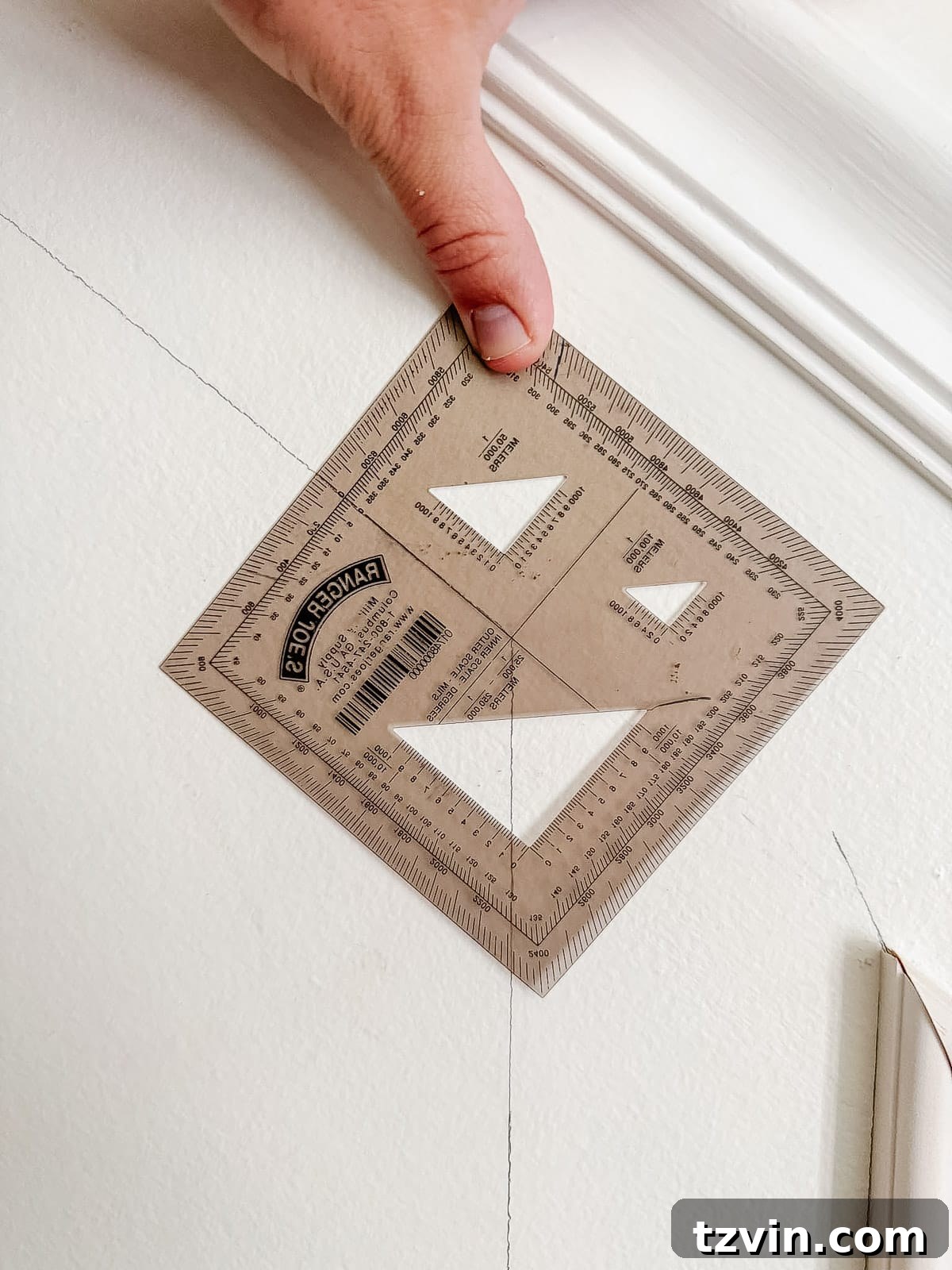Stair Wainscoting Made Simple: A DIY Installation 5 Using a protractor to accurately find molding angles for stair wainscoting