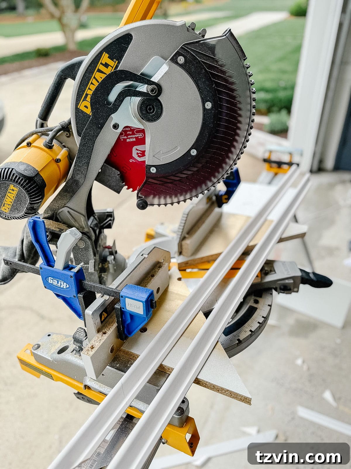 Stair Wainscoting Made Simple: A DIY Installation 8 Picture frame molding on a miter saw with custom jig guide for precise angle cuts