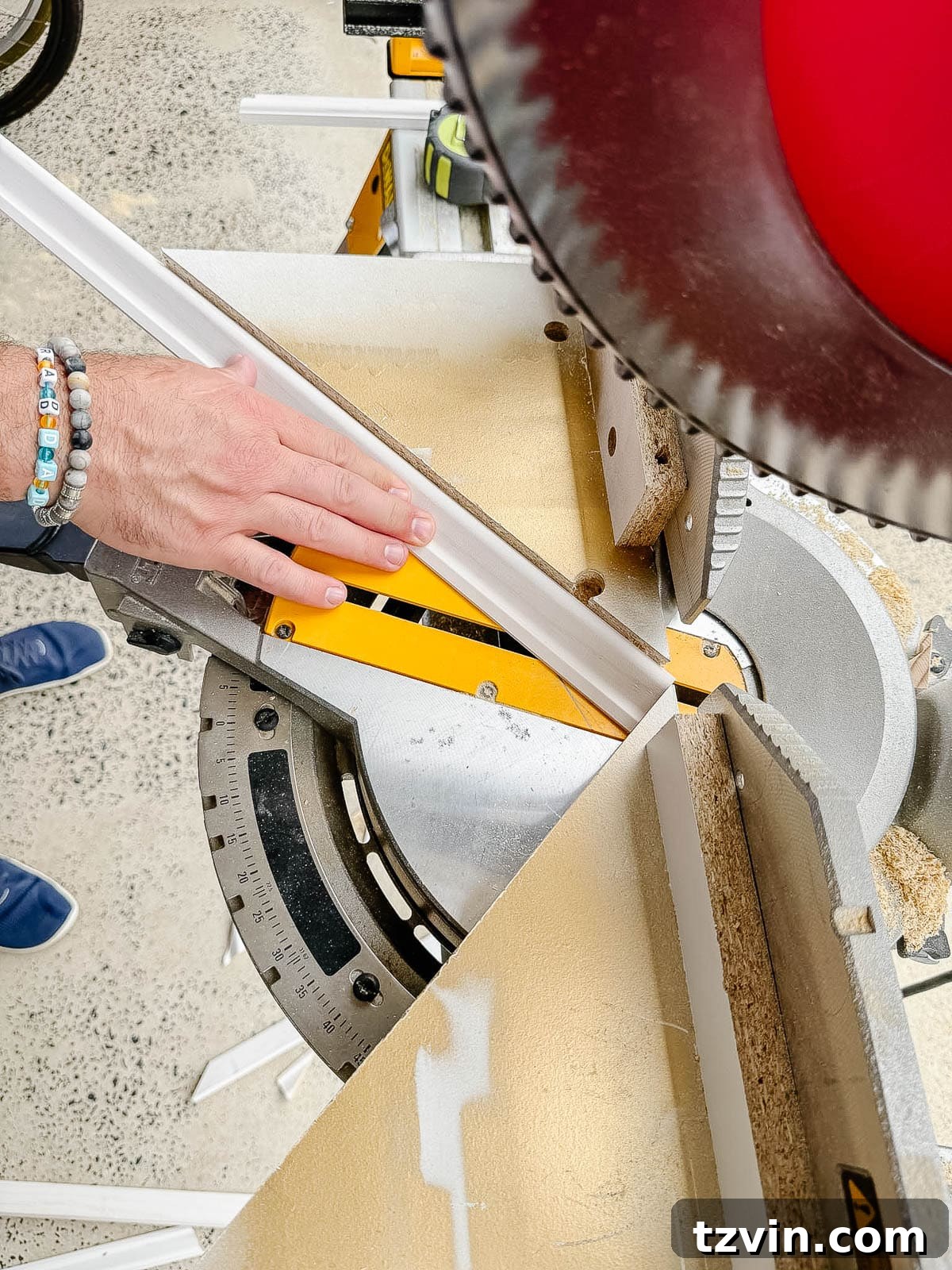 Stair Wainscoting Made Simple: A DIY Installation 9 DIY angle cutting guide securely set up on a miter saw for wainscoting project