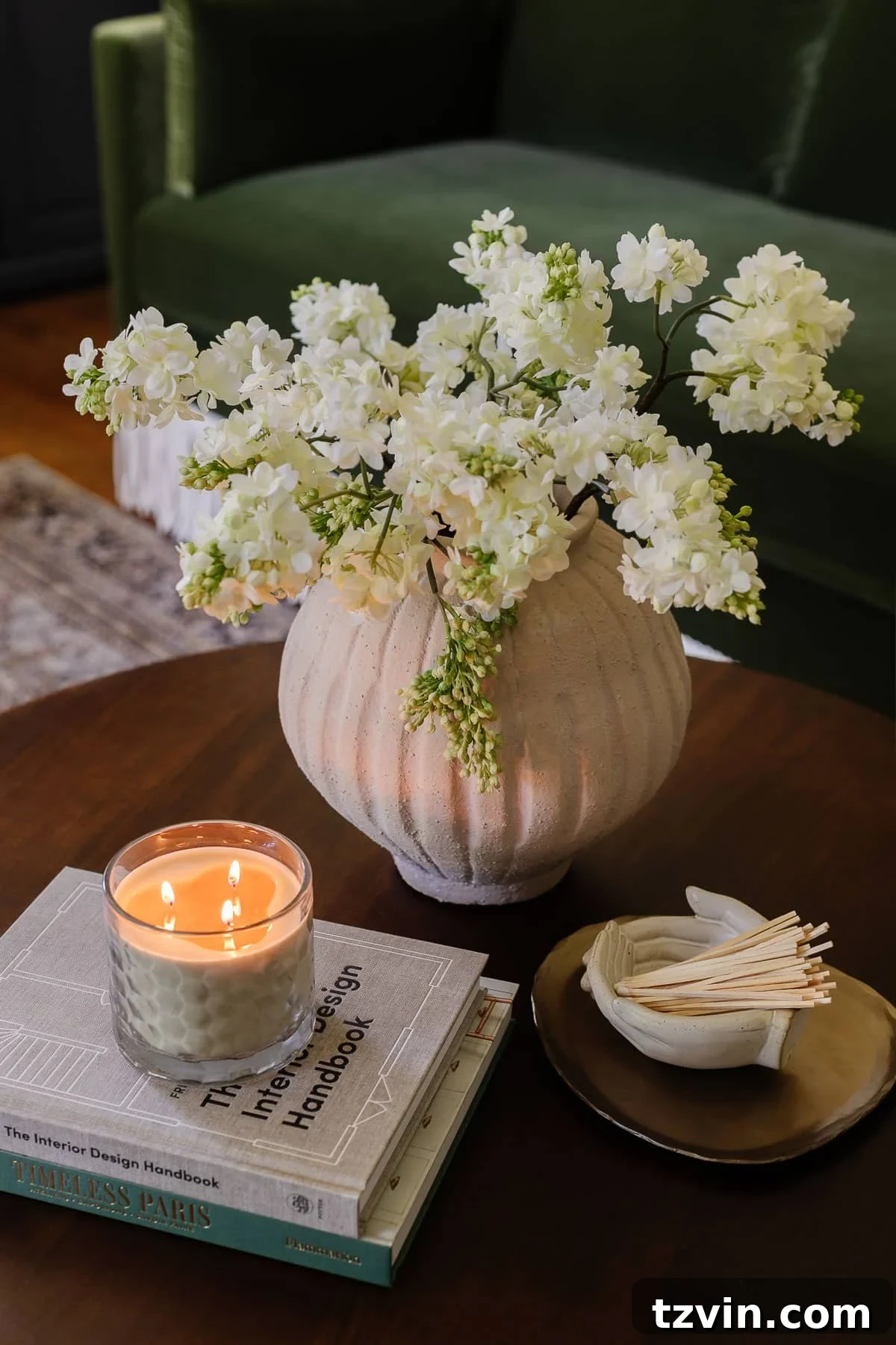 Boost Your Output: Smart Home Office Designs 12 Elegant coffee table decor showcasing a fresh vase of flowers, stylish coffee table books, a scented candle, a decorative tray, and a unique bowl holding matches