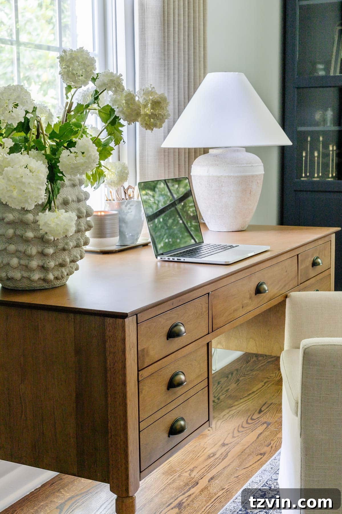 Boost Your Output: Smart Home Office Designs 7 Elegant vintage style wood desk positioned for optimal natural light
