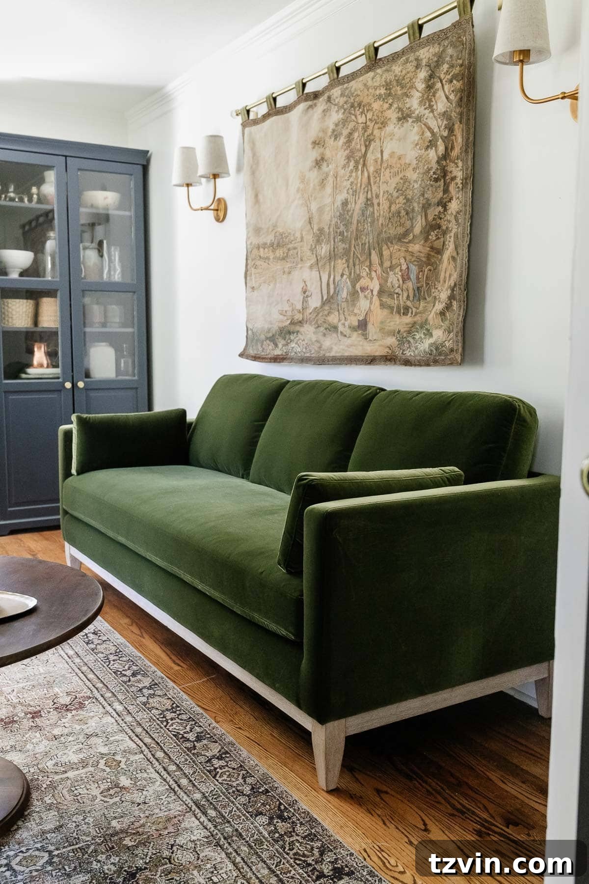 Modern farmhouse green velvet sofa in an office setting before fringe was added
