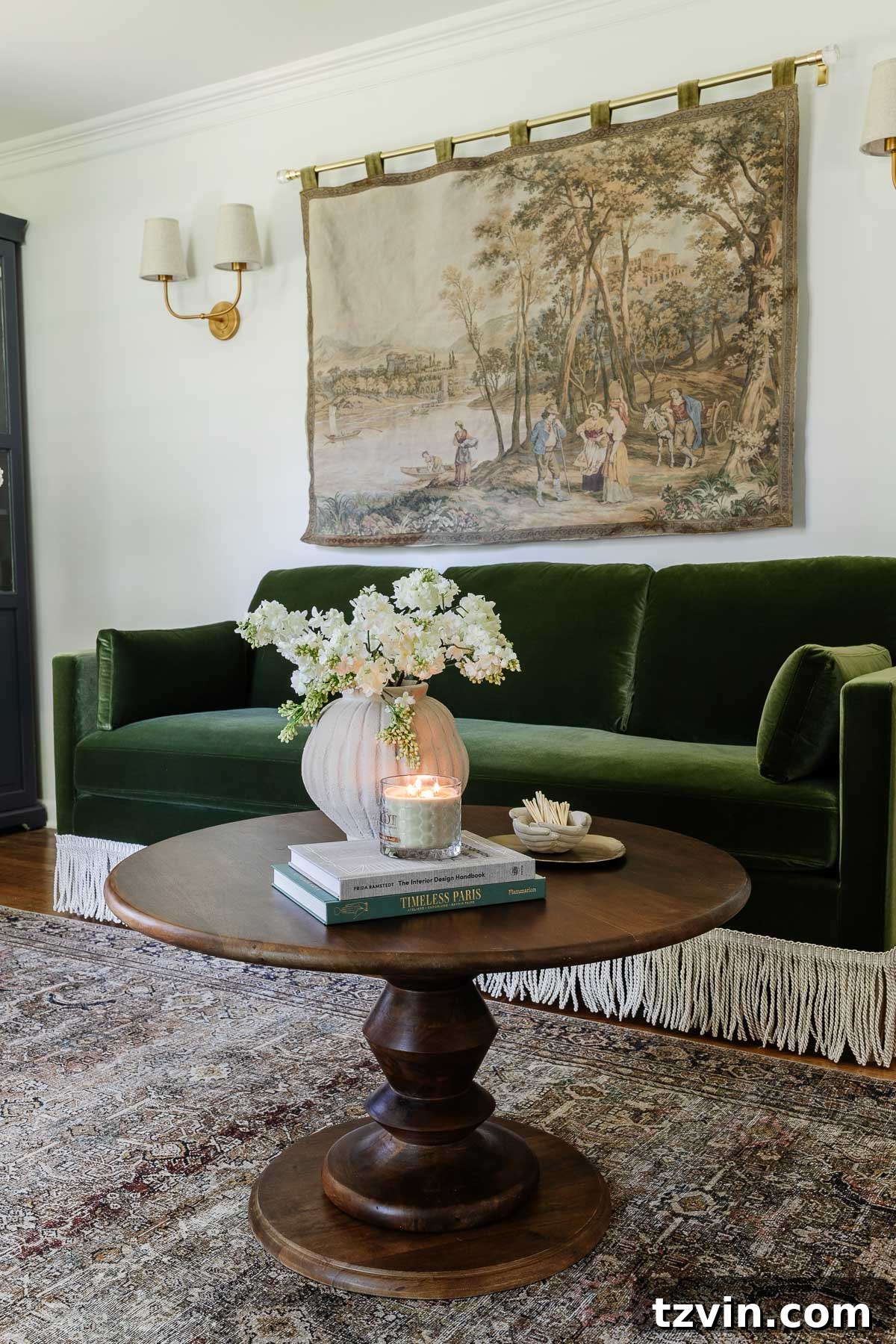 Fringe trim added to a sofa, styled with a chic coffee table and tapestry in an elegant home office