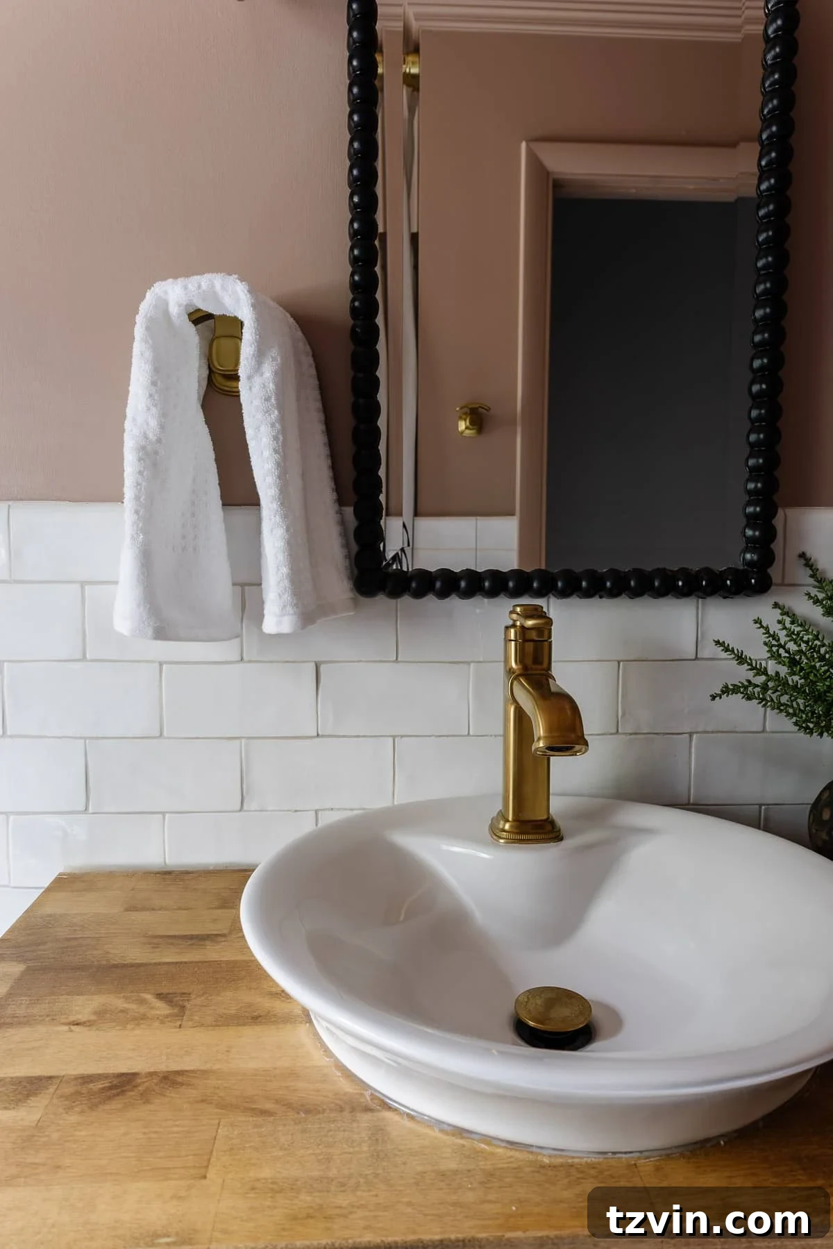 Black and Pink Bathroom Four Day Glow Up 10 Behr Postmodern Mauve pink bathroom with subway tile, black beaded mirror, and gold hooks