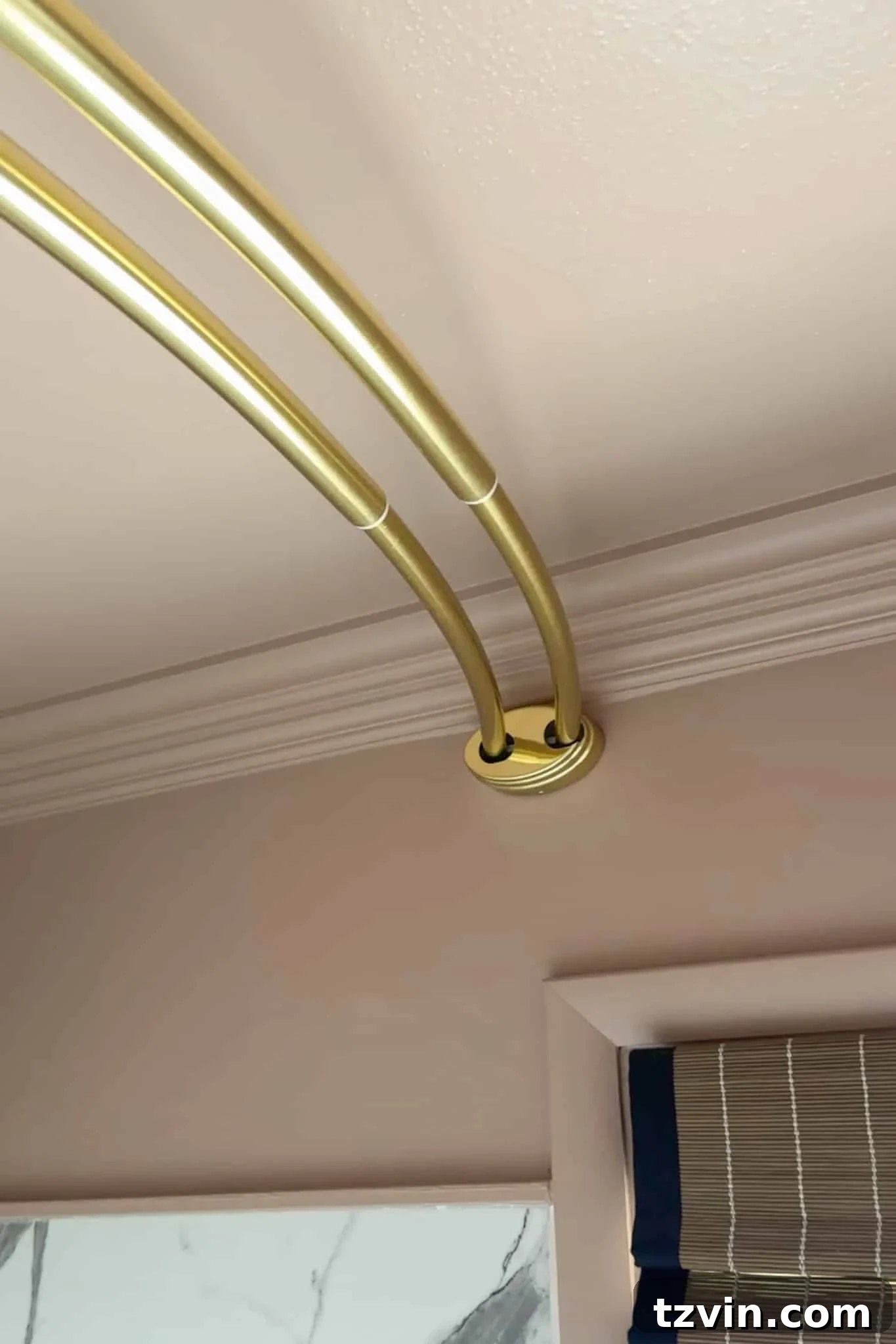 A close-up view of a double shower curtain rod securely installed high on the bathroom wall, just below the crown molding. This shows the ideal placement for creating an illusion of increased ceiling height.