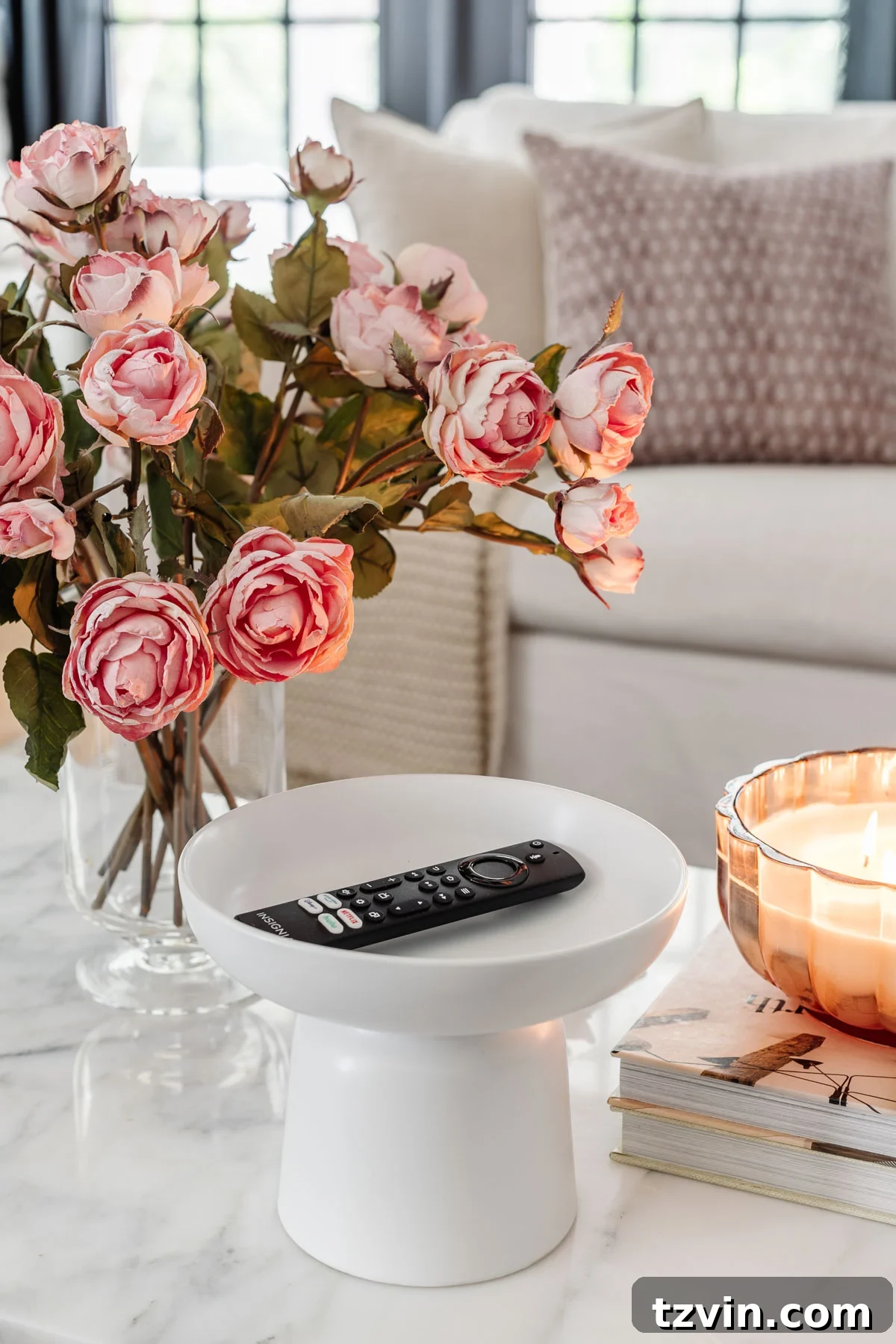 pedestal bowl used as a remote control holder on a coffee table