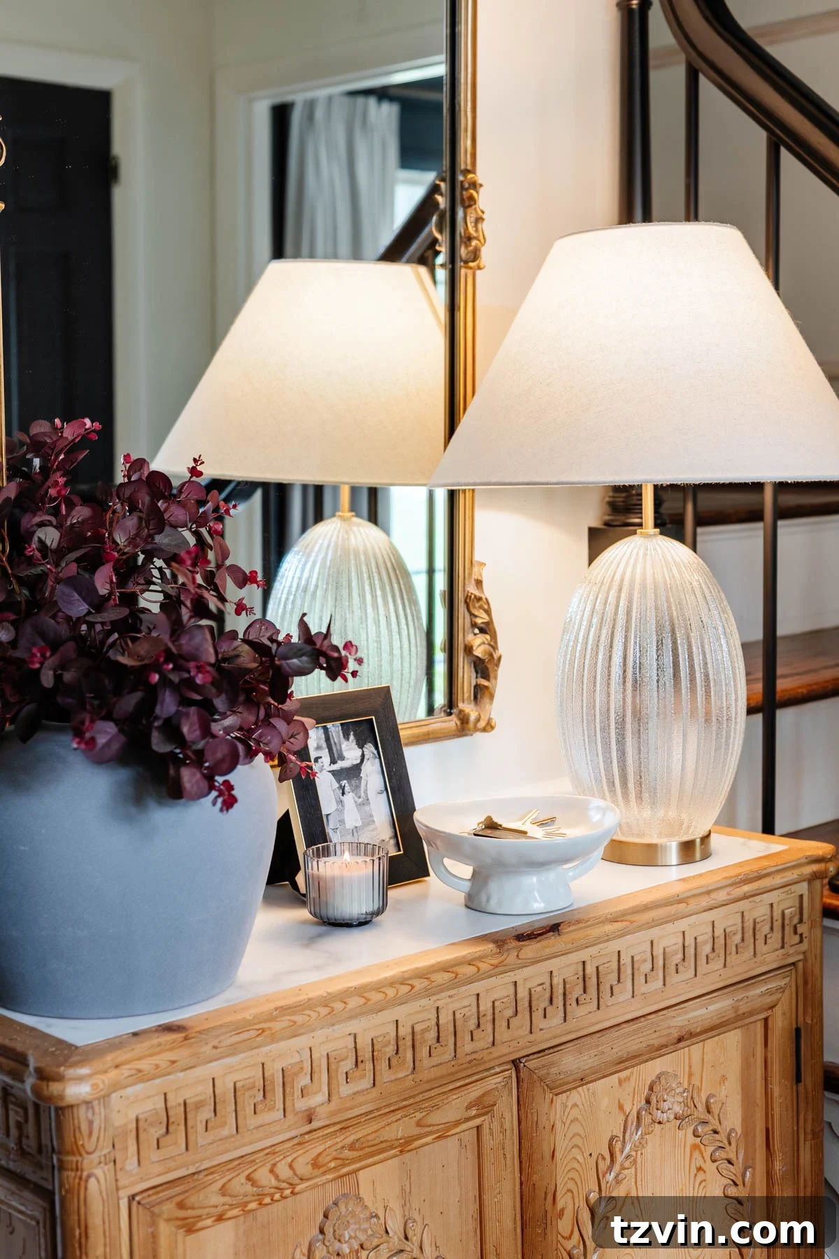 pedestal bowl used as a key holder on an entryway table