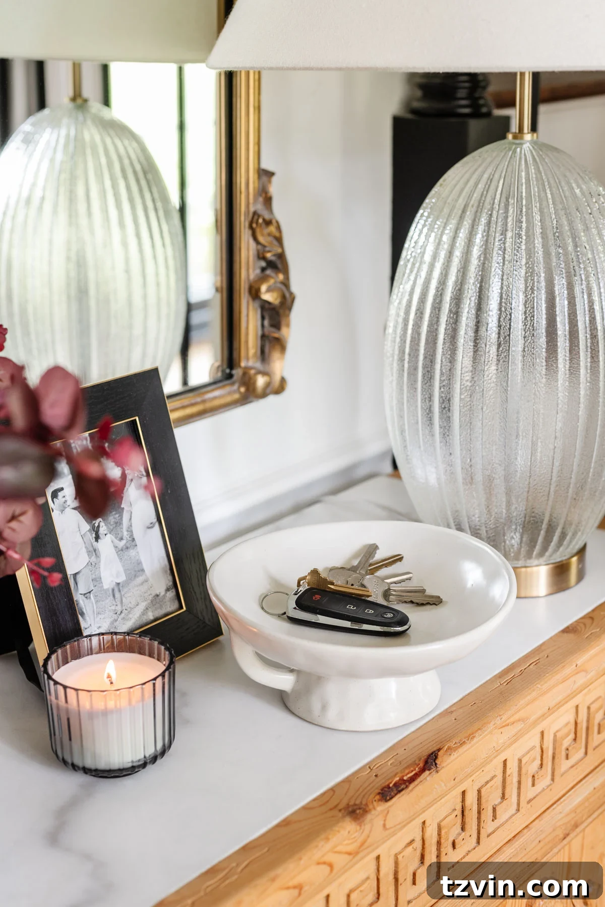 pedestal bowl used as a key holder on an entryway table