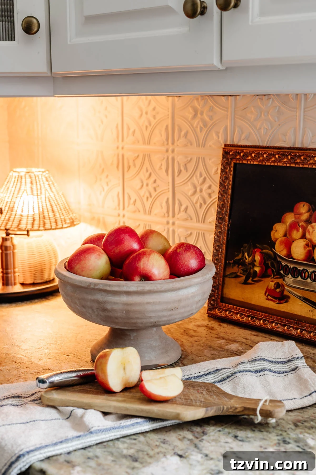 footed bowl used as a fruit bowl on a kitchen countertop