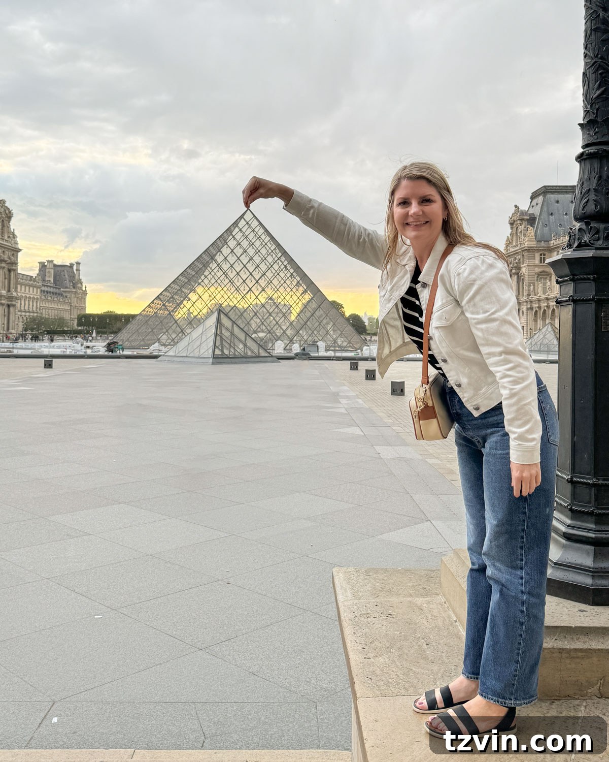 woman in front of the Louvre pyramid