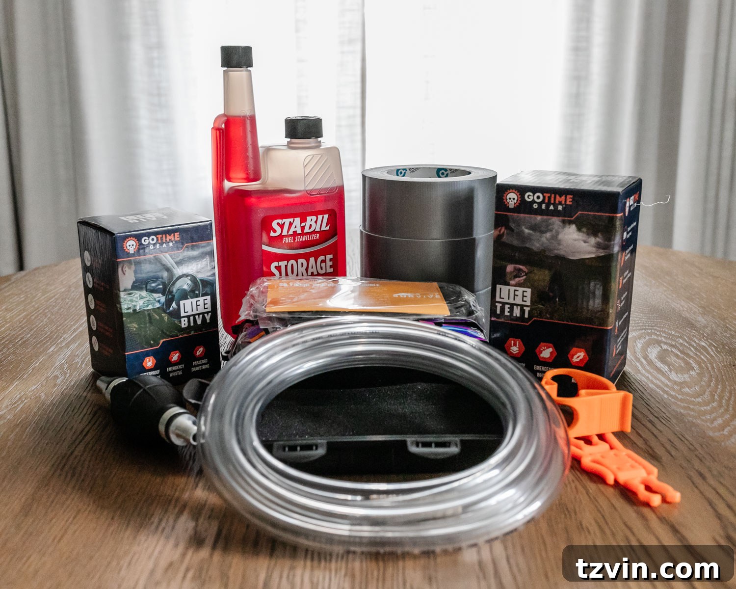 The Ultimate Home Disaster Readiness Kit 8 Essential tools for emergency preparedness, including a survival tool kit, bivy sack, and gas siphon pump, to aid in various disaster scenarios.