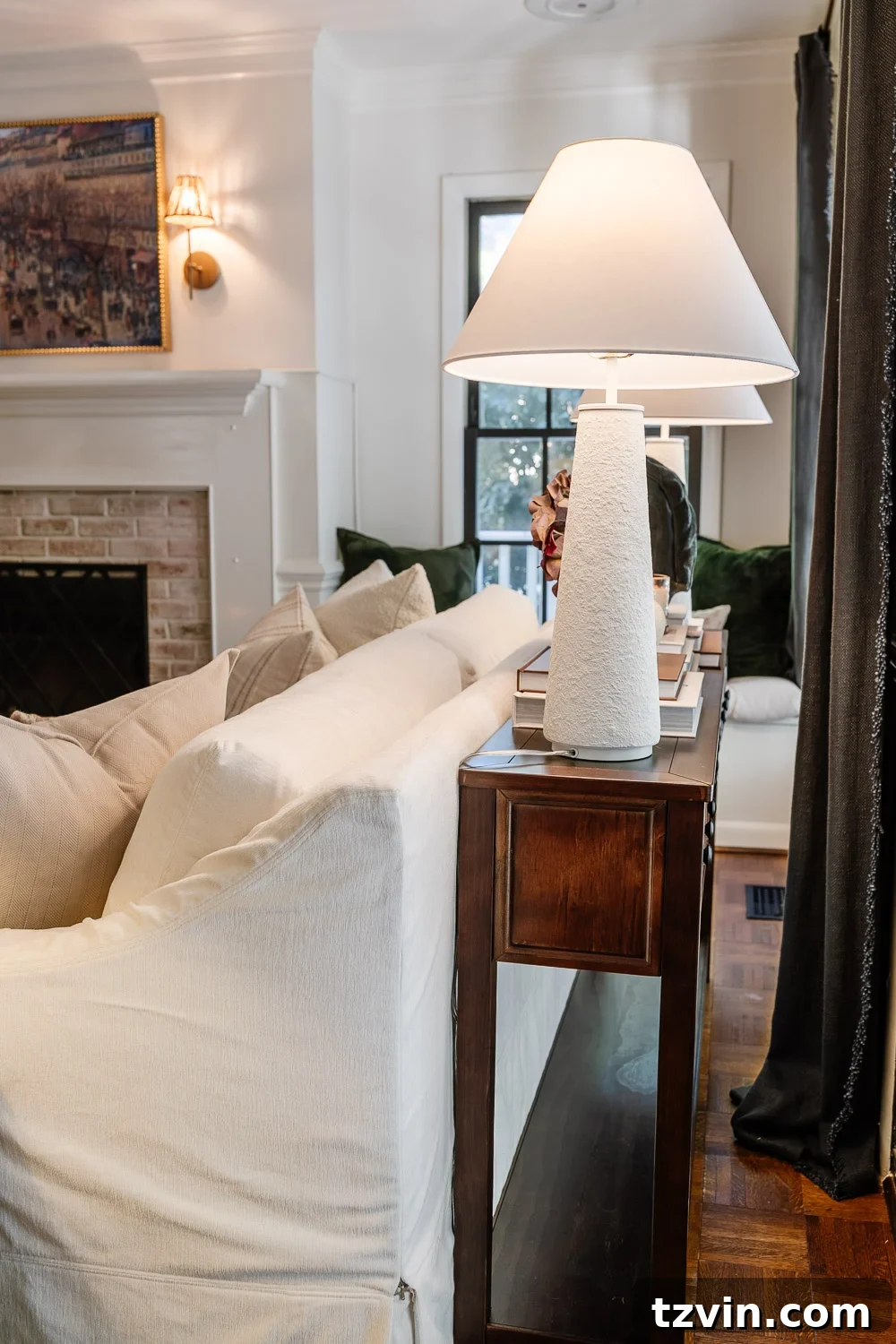 The Sofa Table Mistake You're Making 4 Elegant table lamps on a sofa table providing ambient lighting