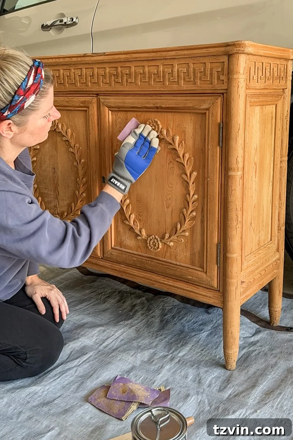 Renew Stained Furniture Without Sanding 5 Lightly sanding the surface of an orange wood cabinet to prepare for gel stain application.