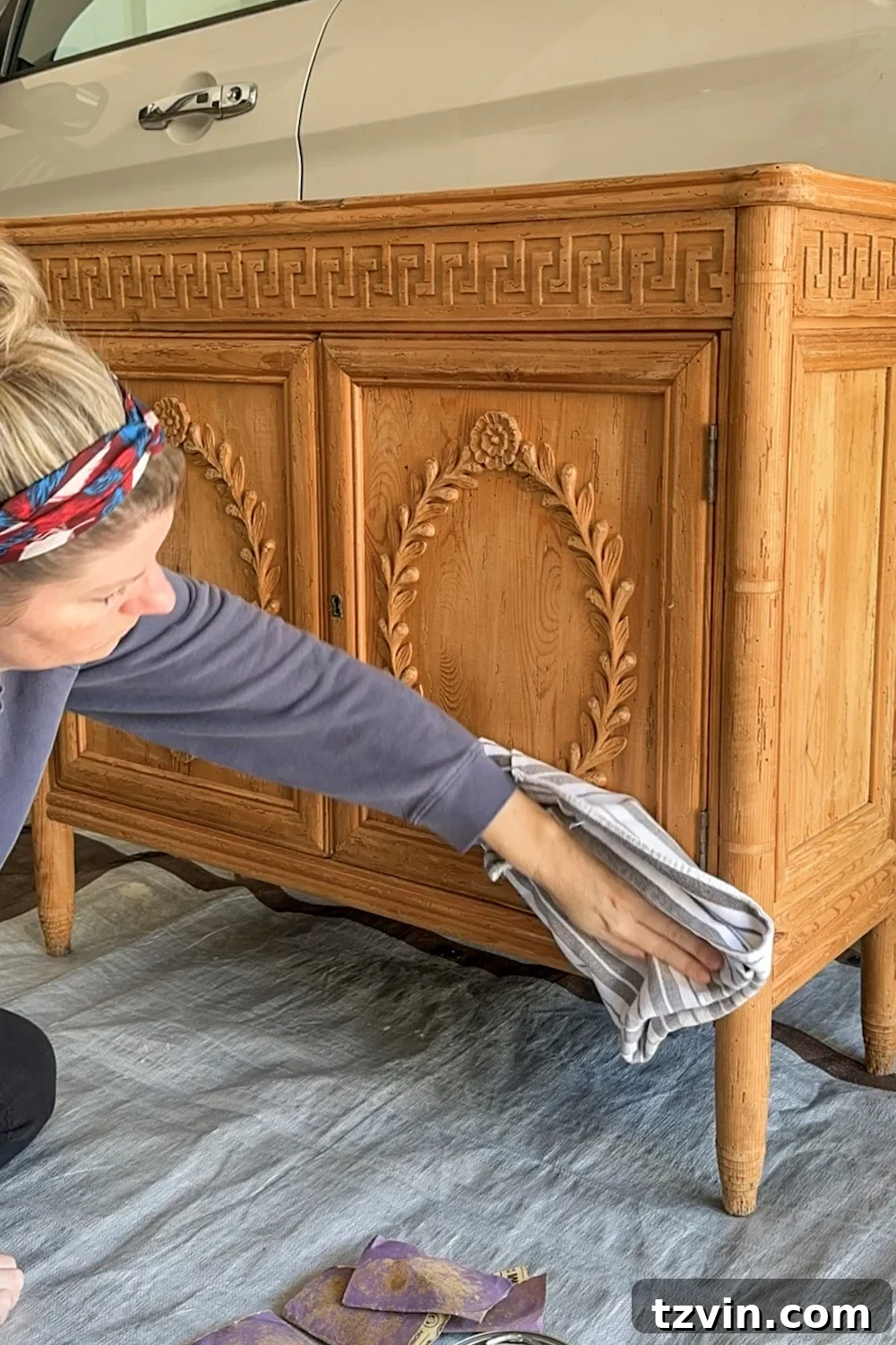 Renew Stained Furniture Without Sanding 6 Wiping away fine sanding dust from the wood cabinet surface to prepare for gel stain.