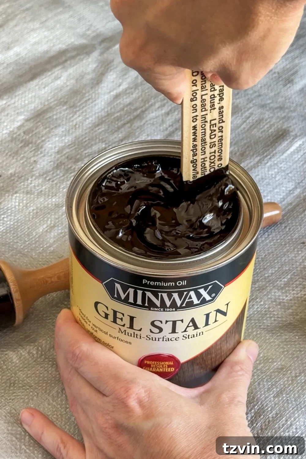 Renew Stained Furniture Without Sanding 7 Stirring a can of Minwax gel stain with a stir stick before application.