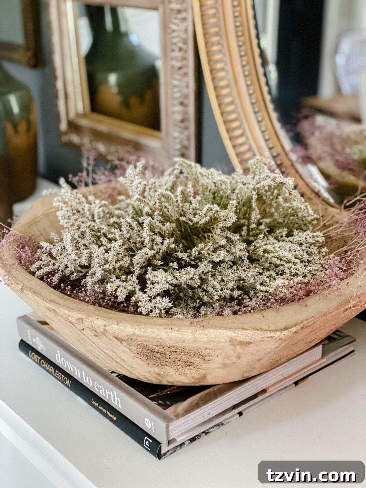 Wooden bowl of dried flowers for natural decor display, showcasing sustainable home styling.