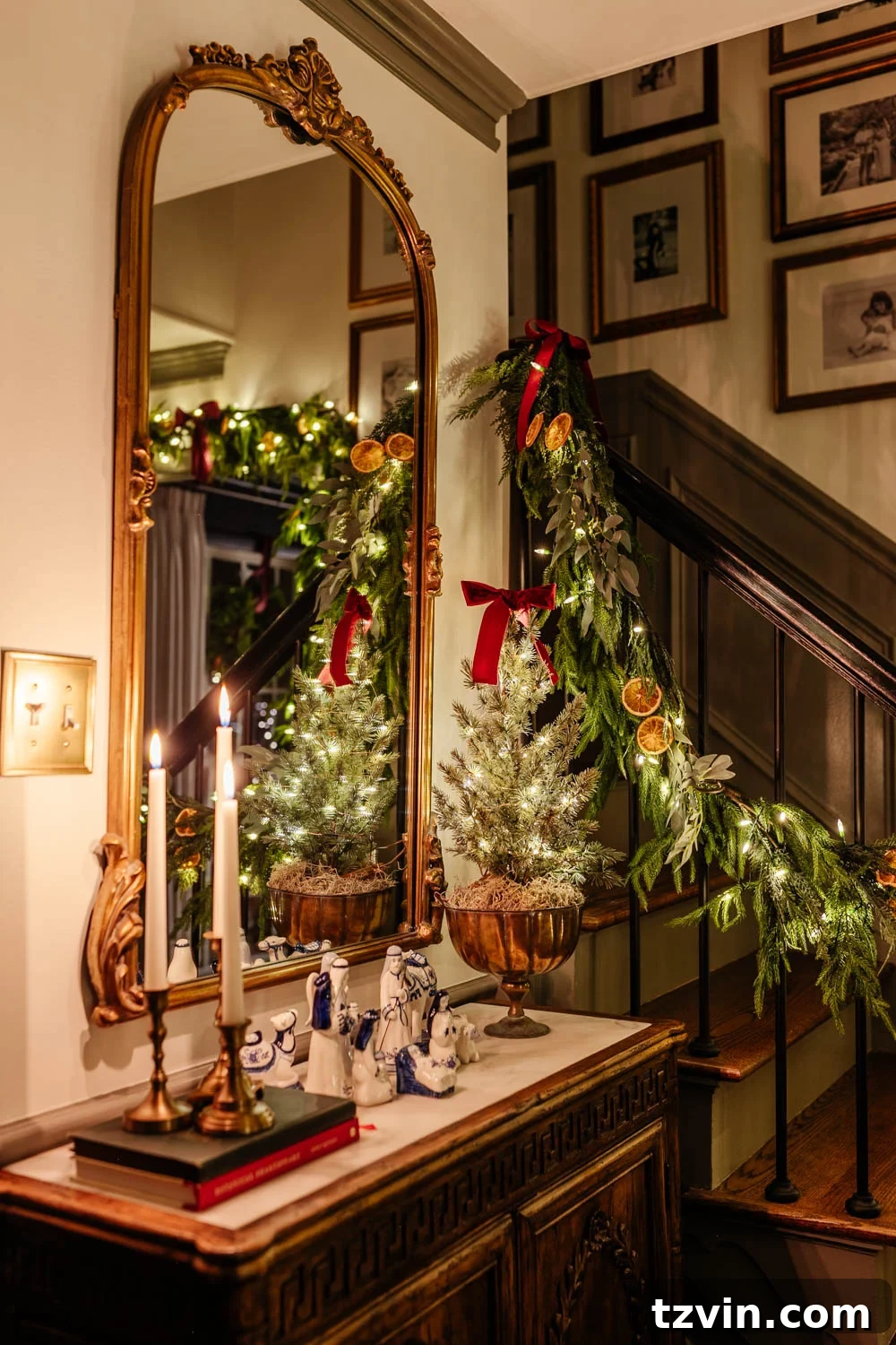 Traditional entryway table with Christmas decor and a nativity scene, bathed in soft candlelight for a peaceful holiday feel.