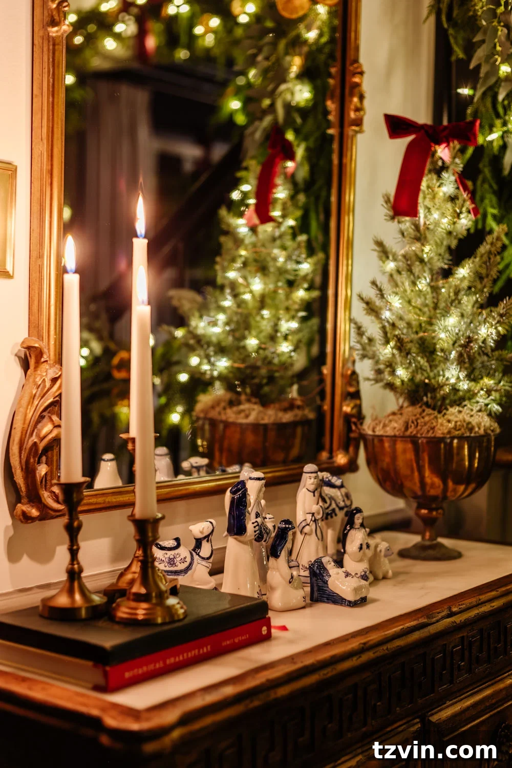 Elegant candlelight Christmas entryway table featuring a nativity display, creating a warm and welcoming atmosphere.