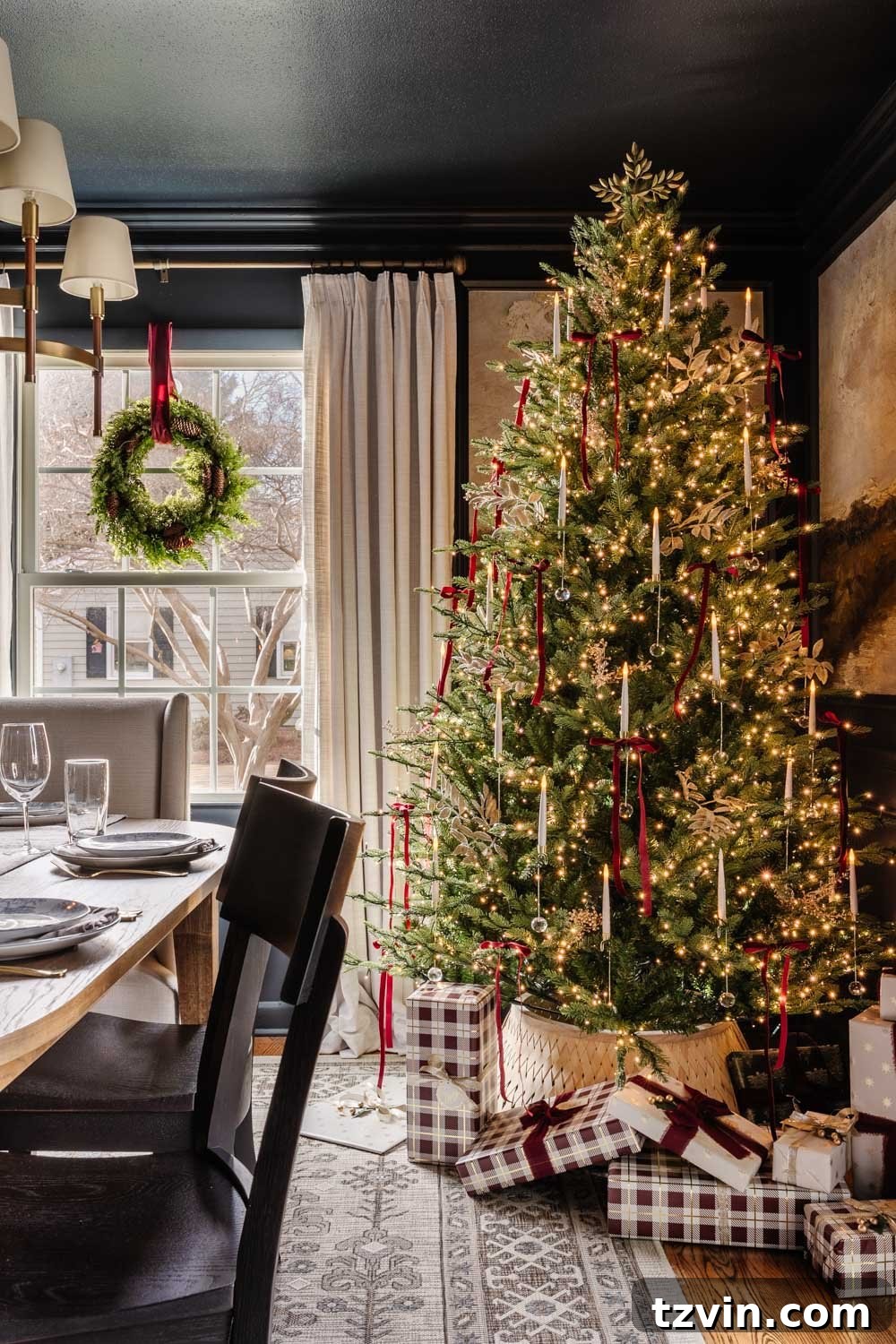 Detailed shot of the dining room chandelier and ceiling, beautifully lit and complemented by Christmas decor below.