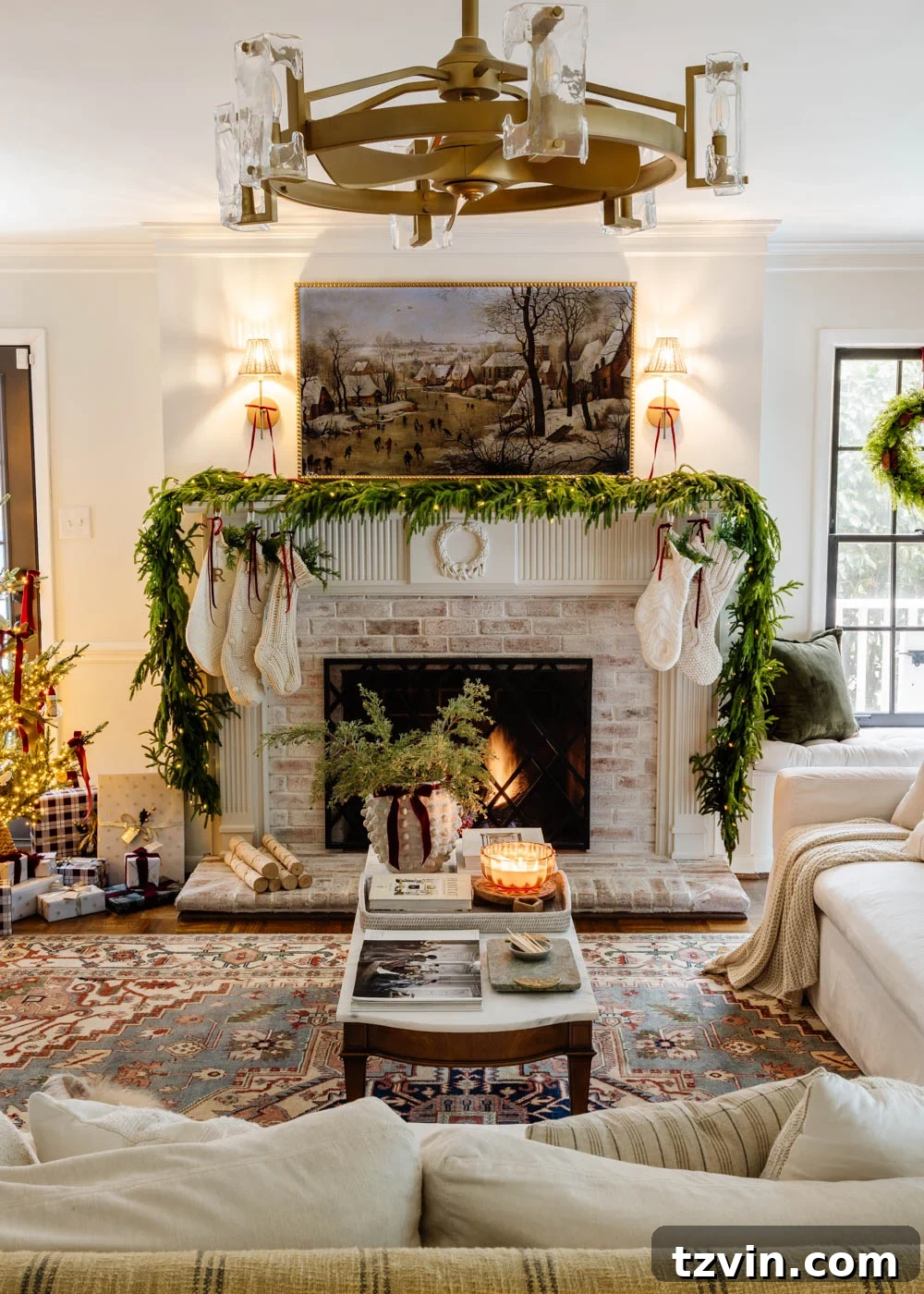 A stylish modern traditional living room decorated for Christmas, highlighting a festive mantel and a beautifully appointed coffee table.