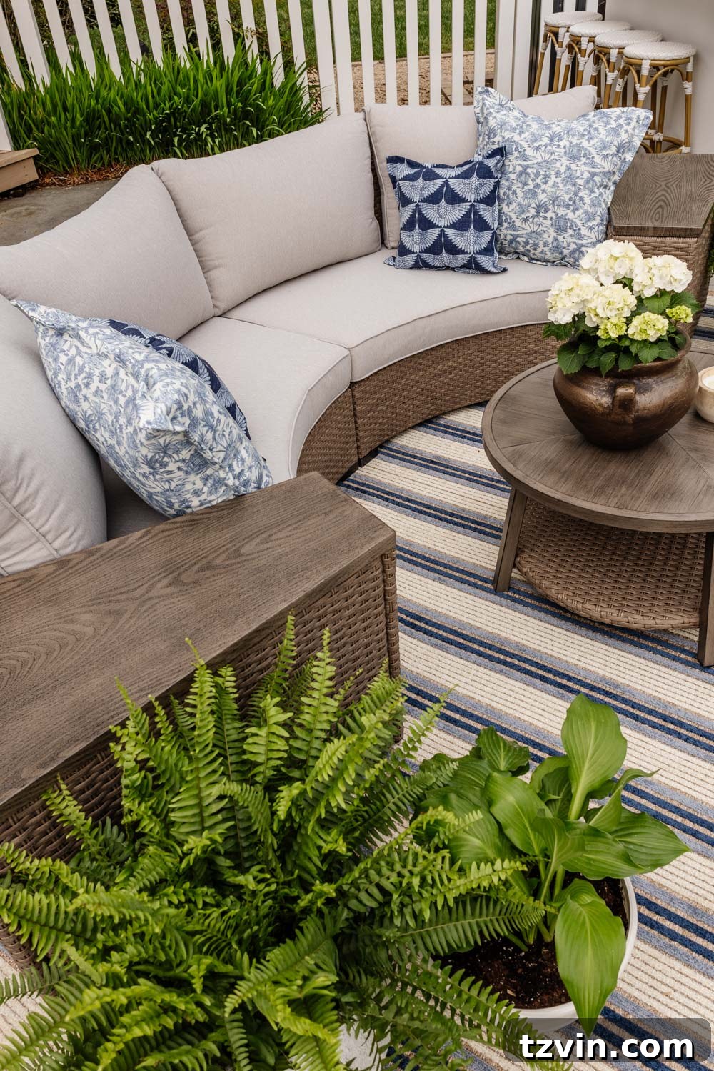 Savvy Buys for Your Outdoor Sanctuary 3 Curved outdoor furniture with integrated storage tables, perfect for family-friendly patios.