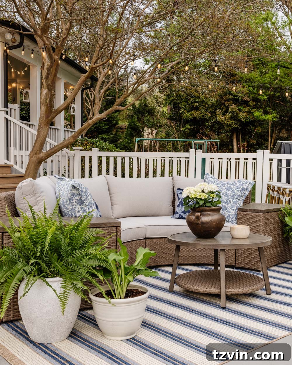 Savvy Buys for Your Outdoor Sanctuary 6 Curved outdoor furniture set adorned with a chic blue striped patio rug, creating a cohesive and inviting outdoor living area.