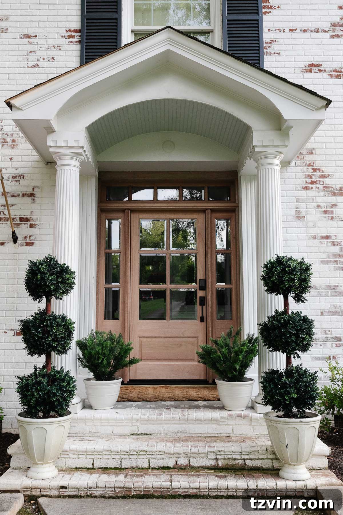 Wow-Worthy DIY Front Yard Transformations 10 Newly installed wood front door replacement, adding natural light and improving home's curb appeal