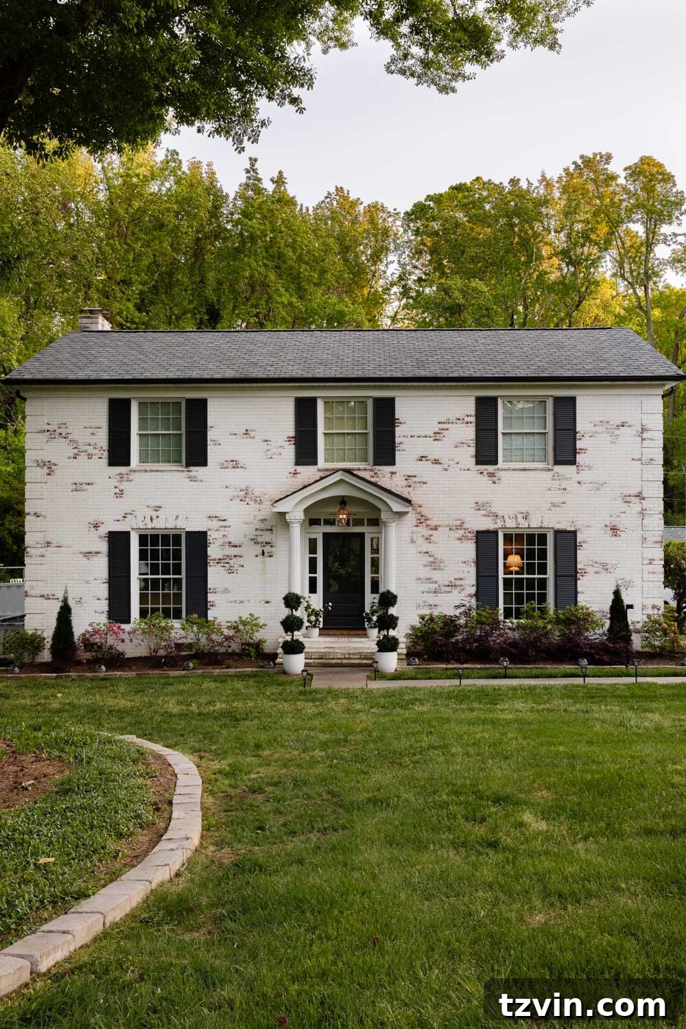 Wow-Worthy DIY Front Yard Transformations 13 Designer shingles roof replacement on a colonial house, showcasing enhanced architectural detail and curb appeal