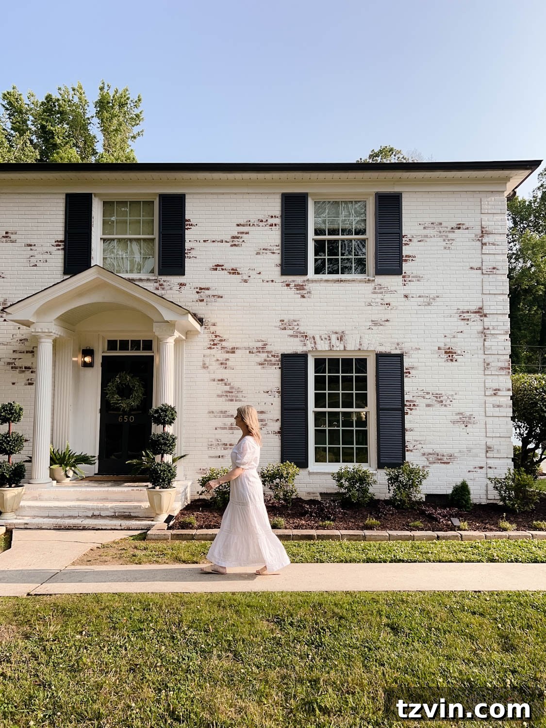 Wow-Worthy DIY Front Yard Transformations 4 Newly limewashed brick colonial house in Romabio Bianco White, highlighting fresh curb appeal