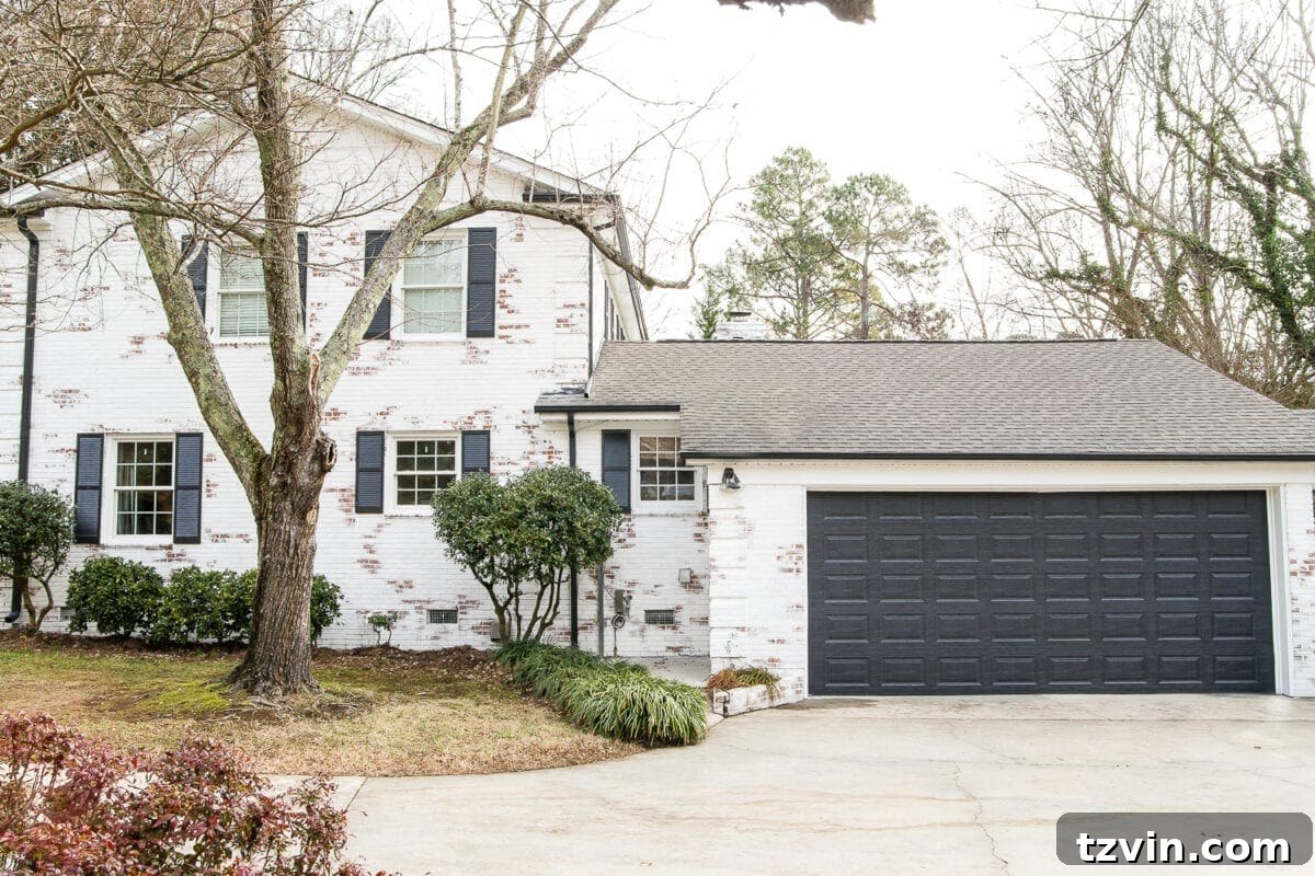 Wow-Worthy DIY Front Yard Transformations 5 Painted garage door in Behr Cracked Pepper complementing a limewashed brick house, enhancing curb appeal