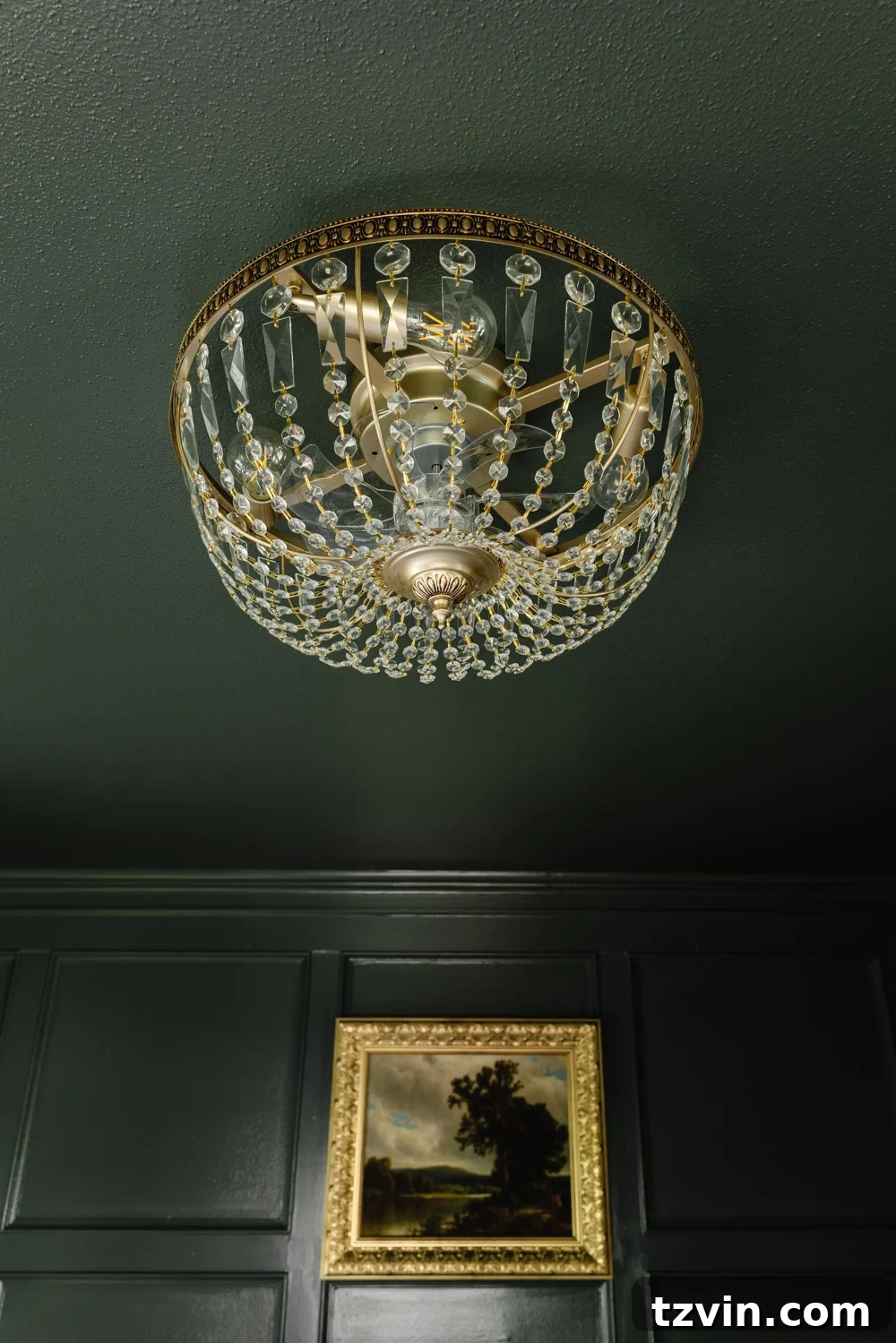 Close-up of a modern crystal fandelier featuring retractable, clear fan blades
