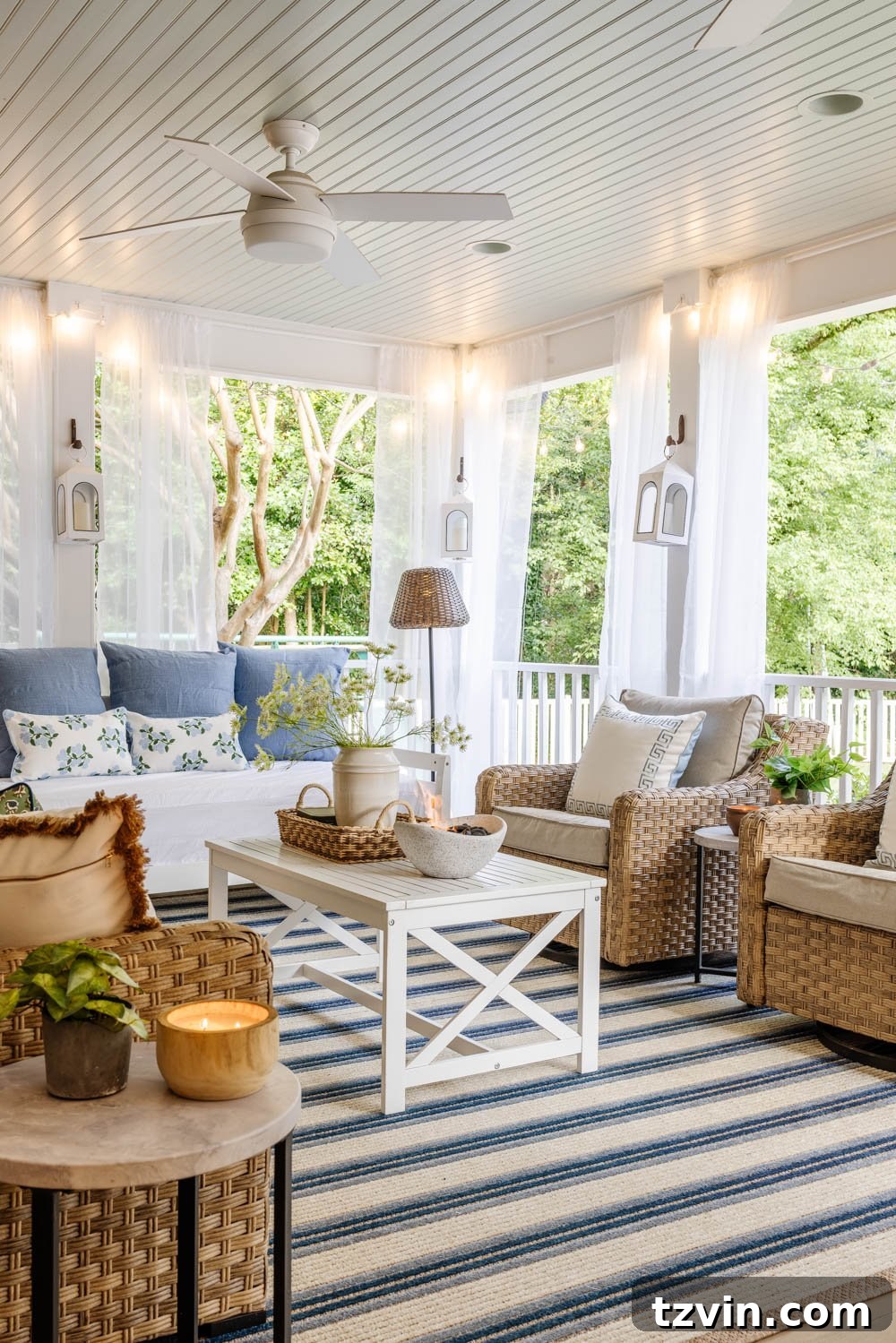 Our DIY Outdoor Living Room: Seamlessly Extending Our Home 2 Serene outdoor living room with a cozy fireplace on a back porch, adorned with soft pillows and string lights.