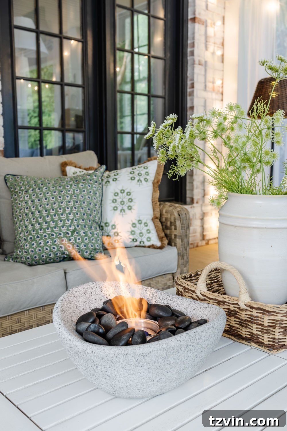 Our DIY Outdoor Living Room: Seamlessly Extending Our Home 15 Outdoor living room with a modern fire bowl, comfortable seating, and soft lighting on a back porch.